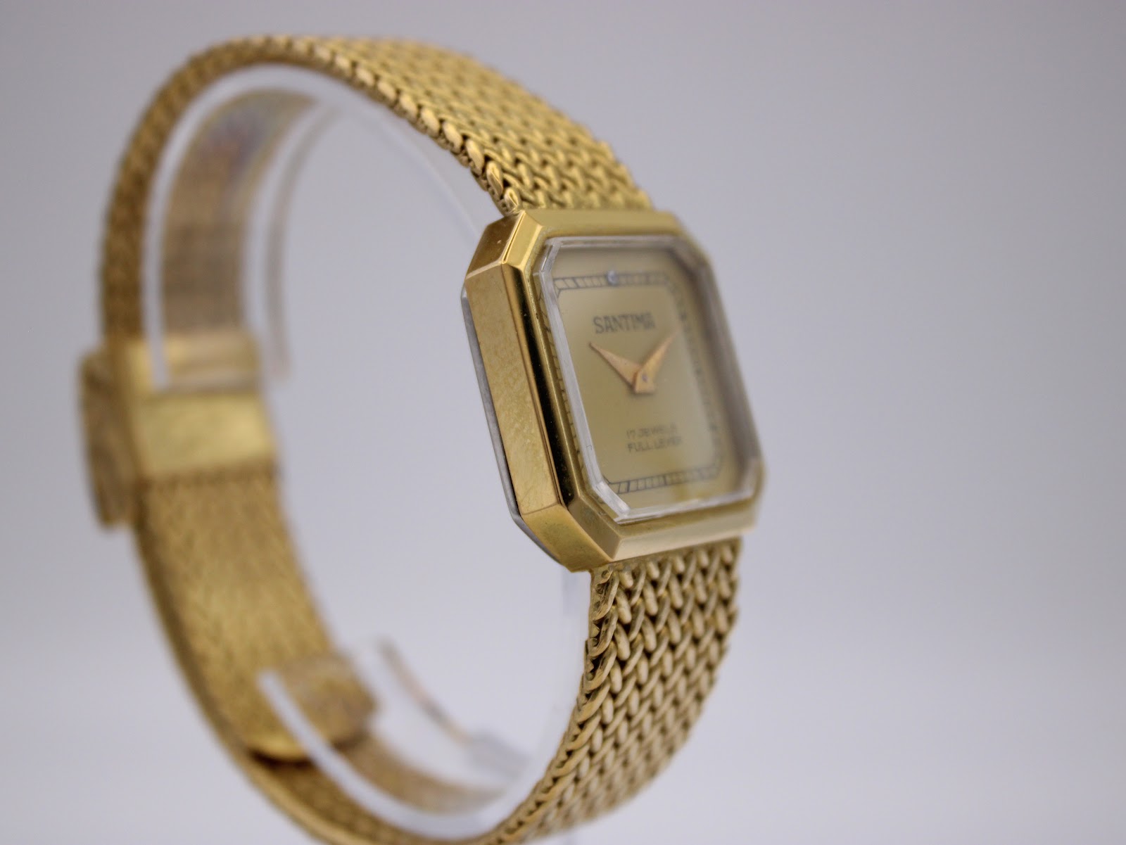 Another angled view of Santima watch on a stand, showcasing the sharp lines of the octagonal case.