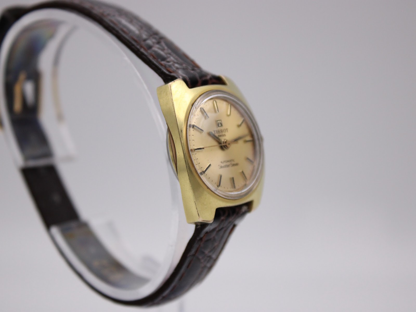 Angled view of the Tissot Seastar Seven showing the dial, case and textured brown leather strap.