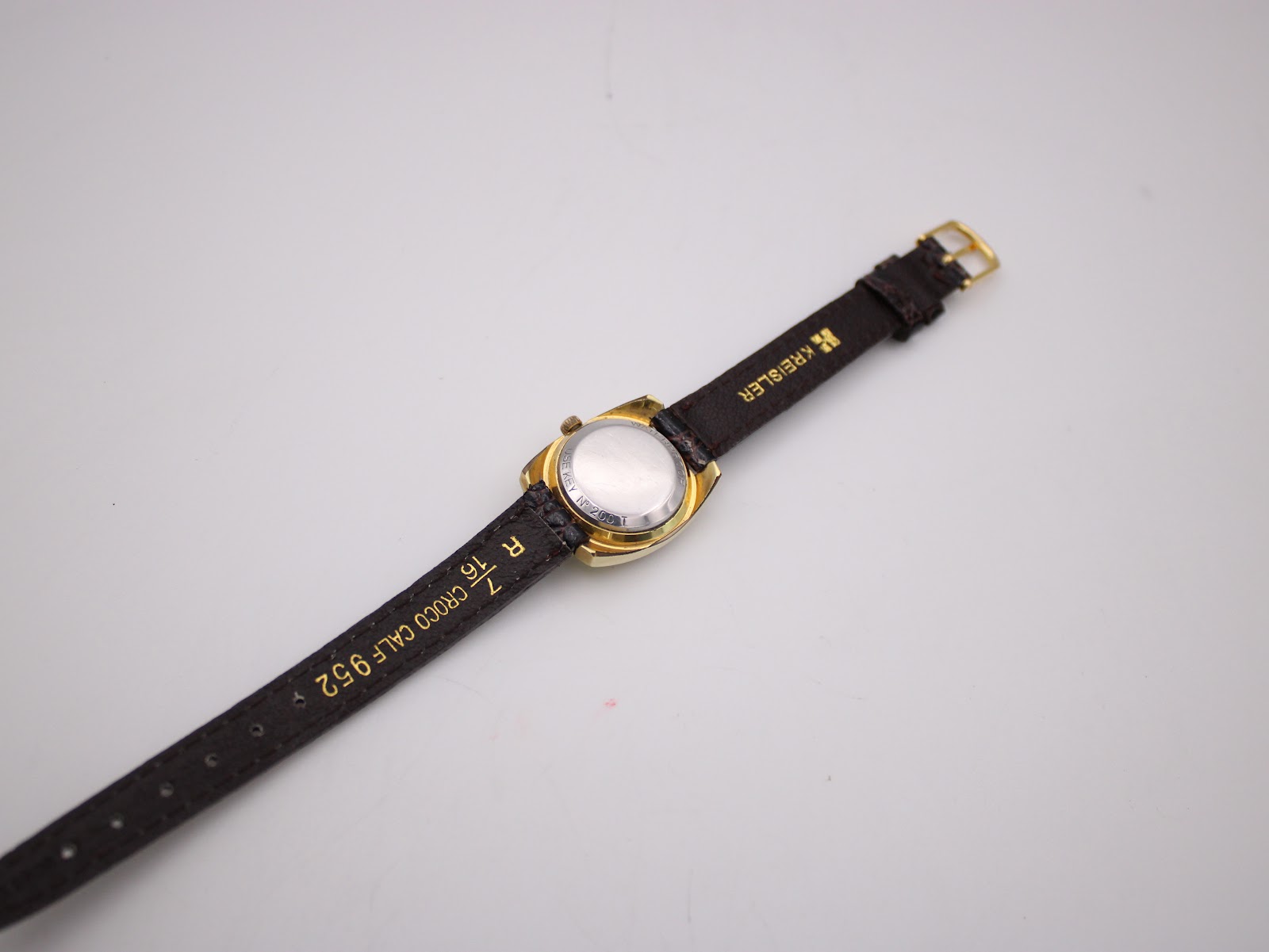 Back view of the watch showing the stainless steel case back and 'CROCO CALF' inscription on the strap.