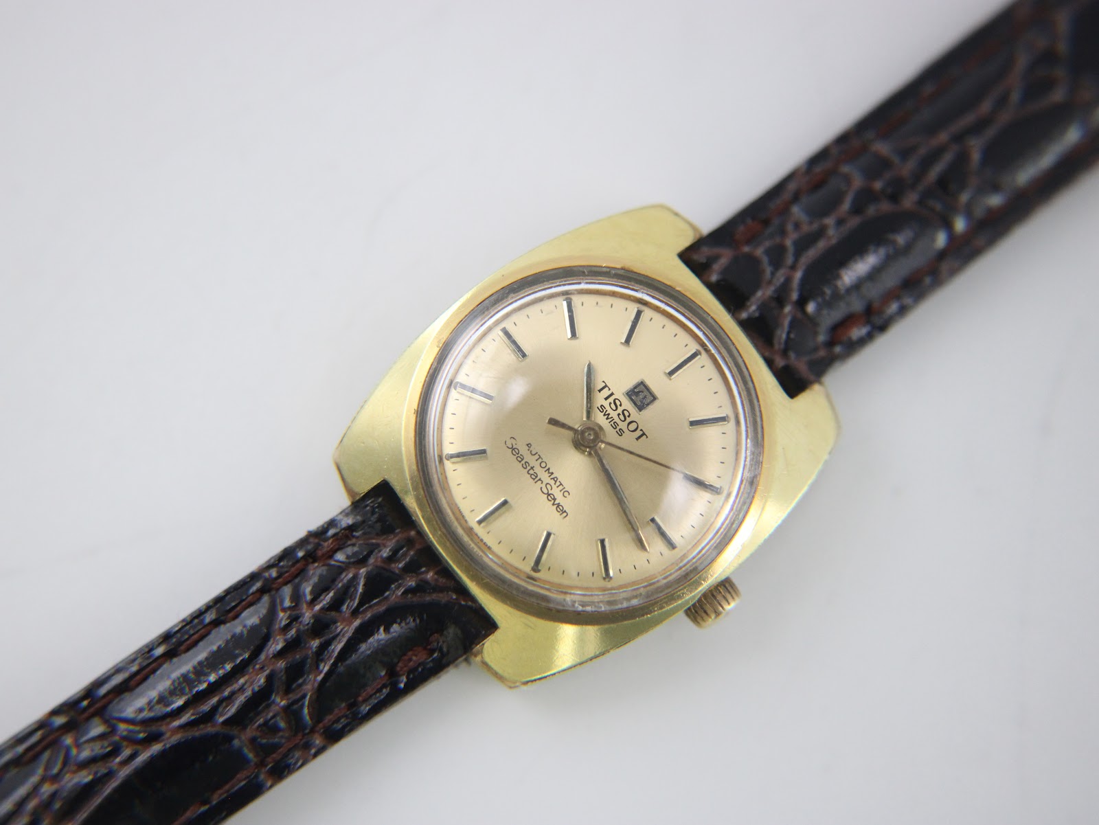 Close-up front view of the Tissot Seastar Seven dial, showing brand, model, automatic text and baton indices.