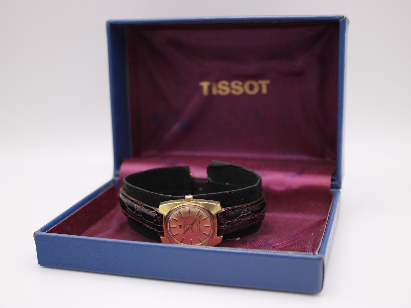The Tissot Seastar Seven watch presented inside its original blue Tissot box with purple interior.