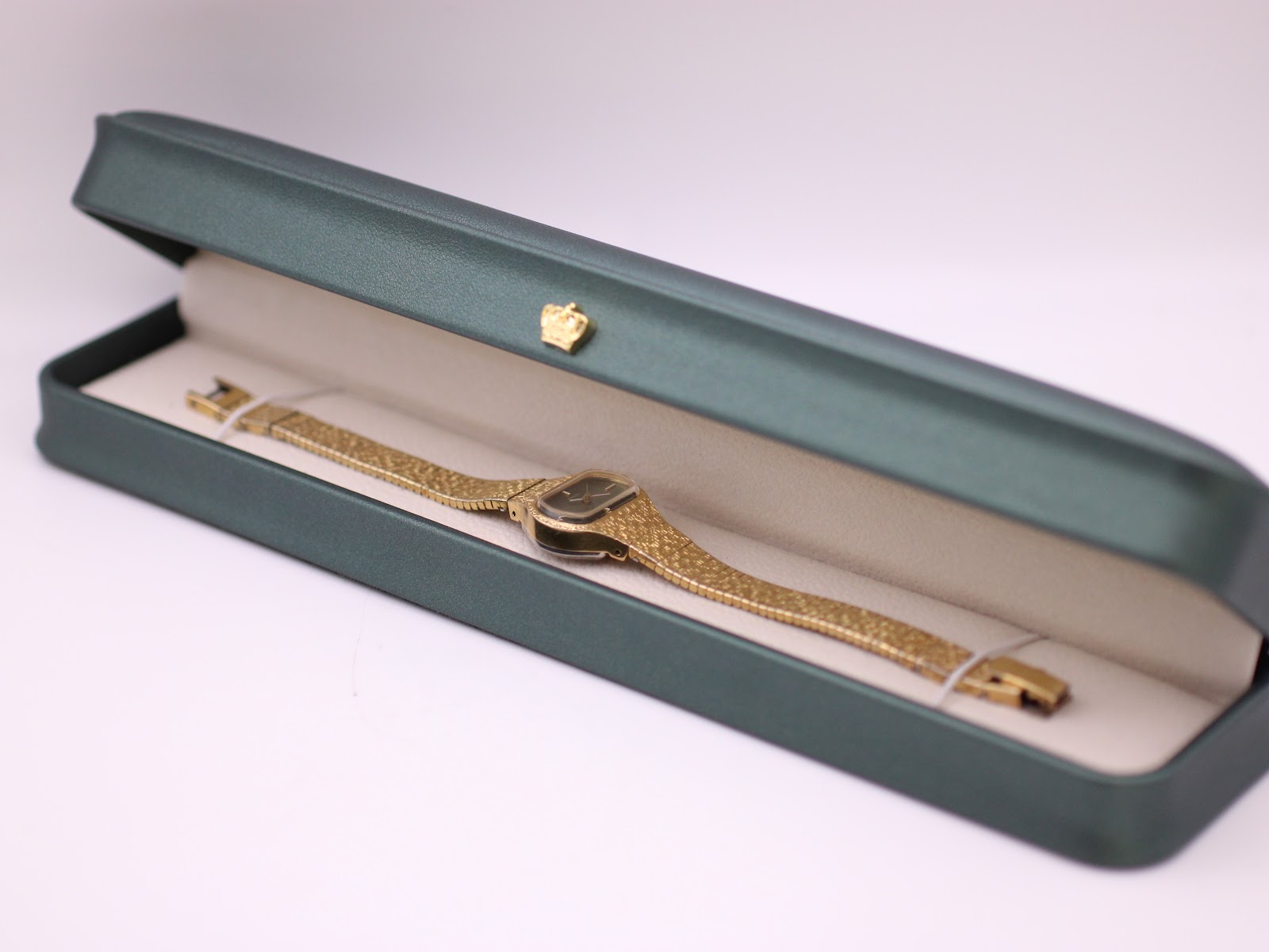Seiko Rainbow watch presented inside its original dark green rectangular presentation box with a cream interior.