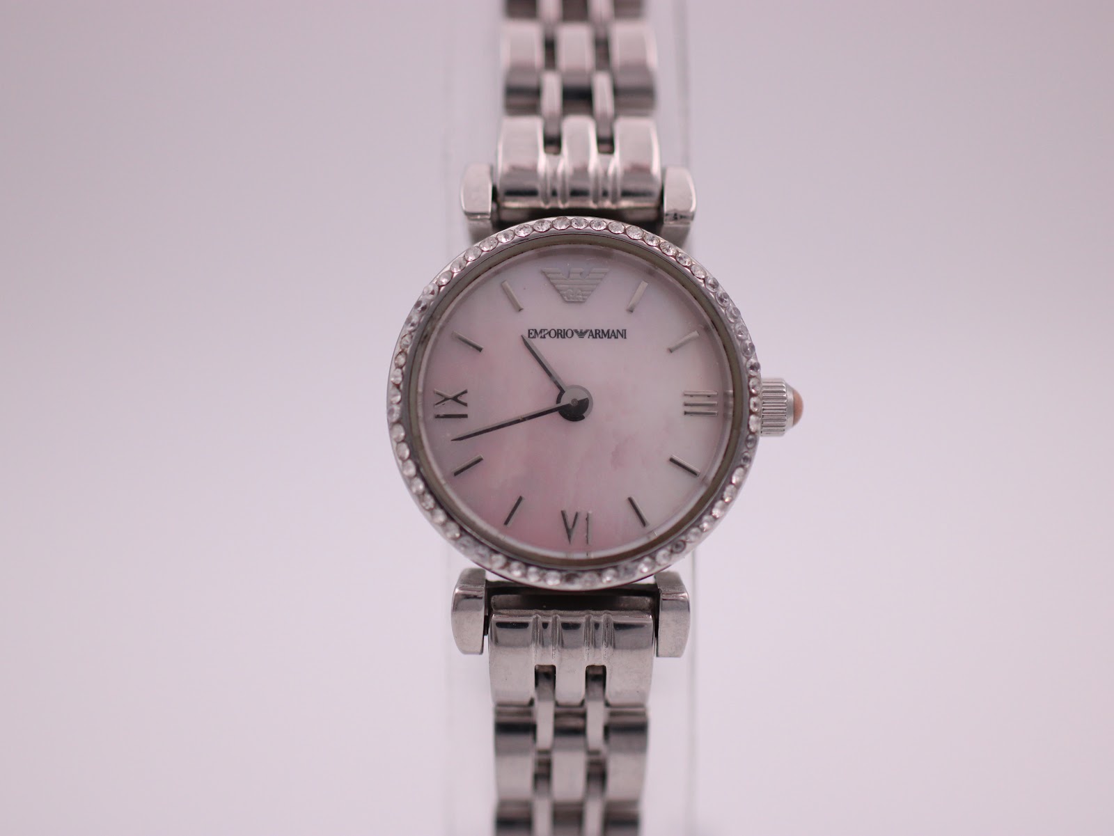 Front view of the Emporio Armani AR-1781 ladies' watch with an iridescent mother-of-pearl dial, silver hands, Roman numerals and a crystal-set bezel.