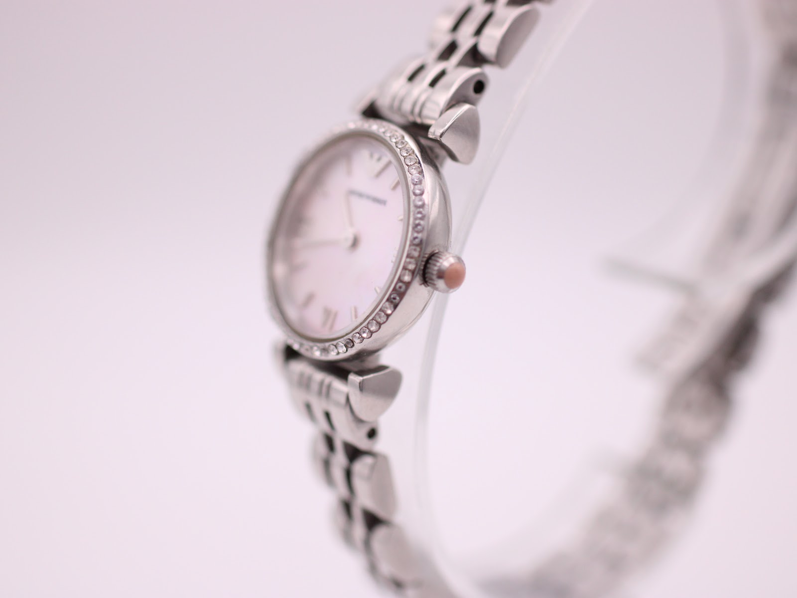 Side profile view of the Emporio Armani AR-1781 watch, showing the polished stainless steel case, crystal bezel, and small crown.