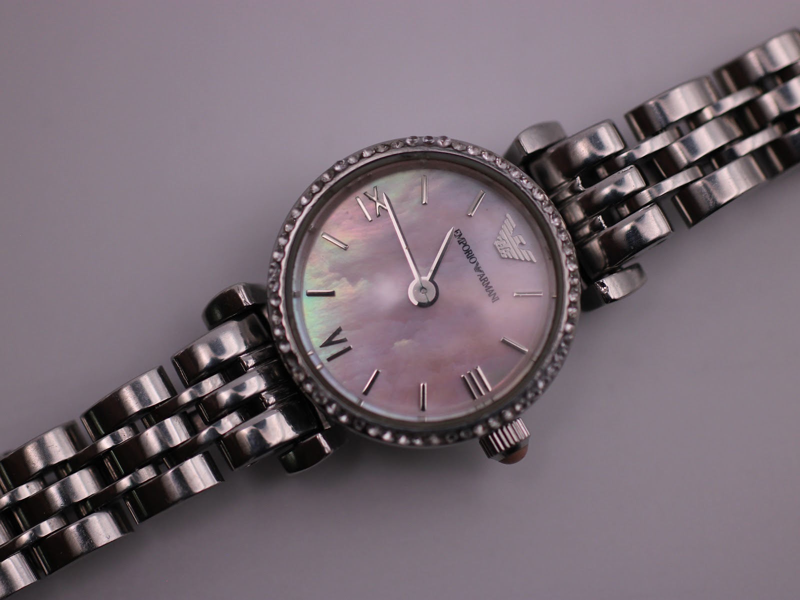 Close-up of the Emporio Armani AR-1781's mother-of-pearl dial, showing the luminous iridescence, Roman numerals, baton indices, and eagle logo.