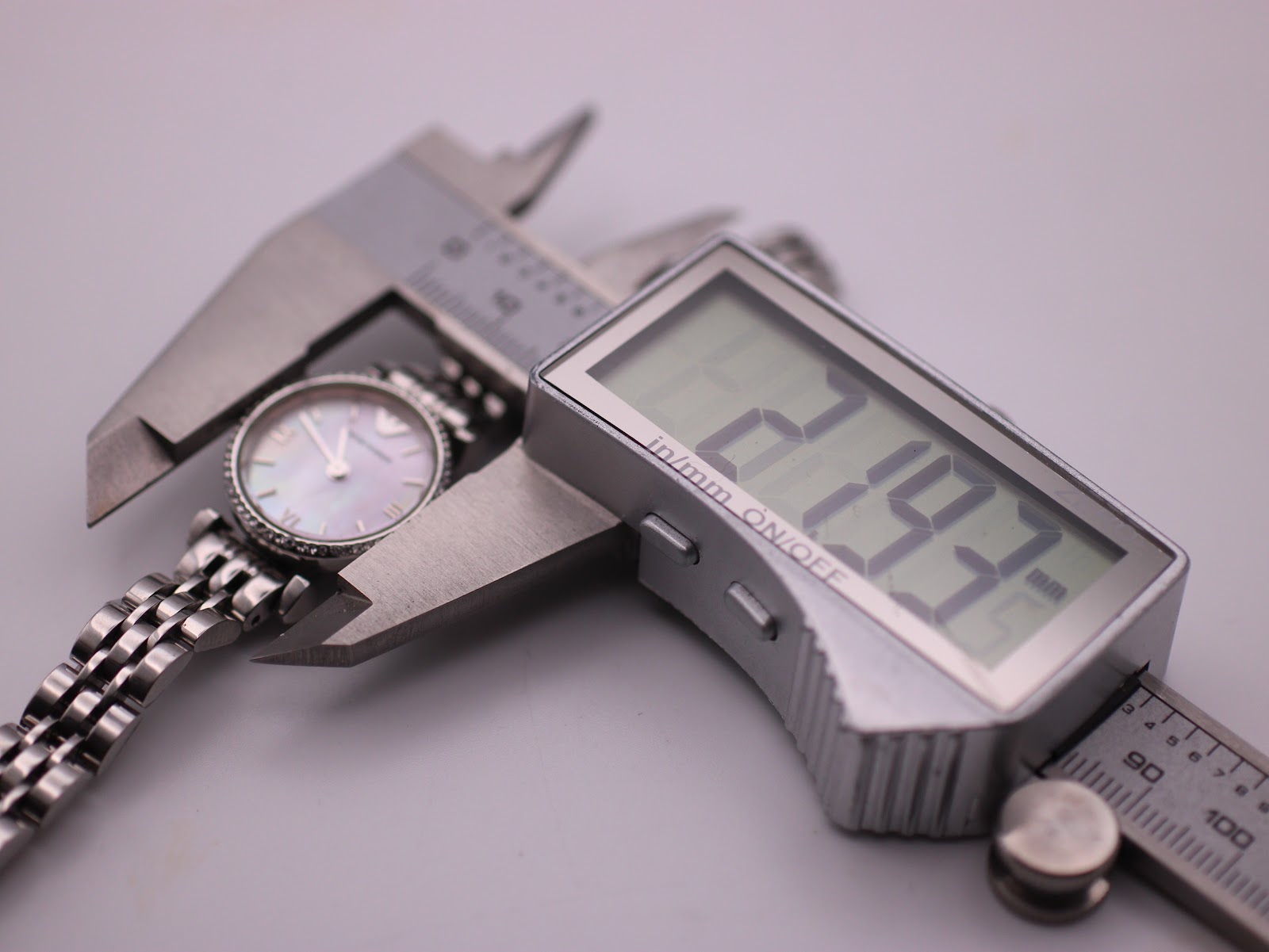 A digital caliper measuring the Emporio Armani AR-1781 watch case diameter at 21.93mm, confirming its petite size.