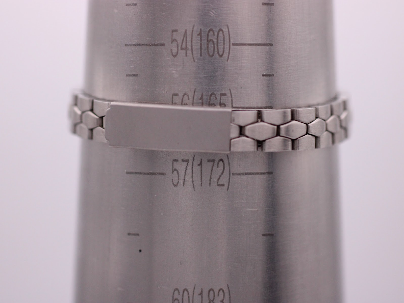 Wrist sizing gauge showing the steel bracelet fits approximately 16.5cm / 165mm wrist circumference.