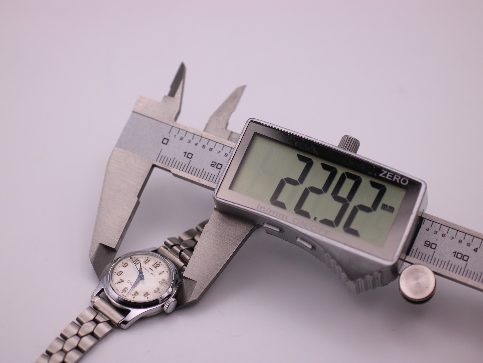 Digital caliper measuring the Jaquet-Droz watch case diameter at 22.92mm.