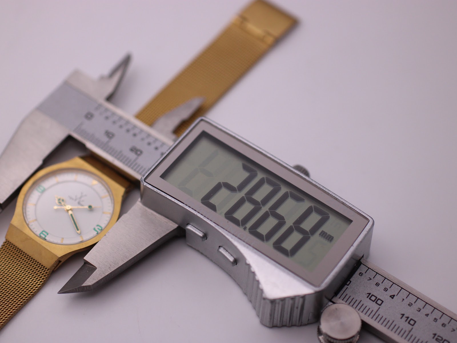 Digital caliper measuring the case diameter of the Toy Watch at 28.68mm.