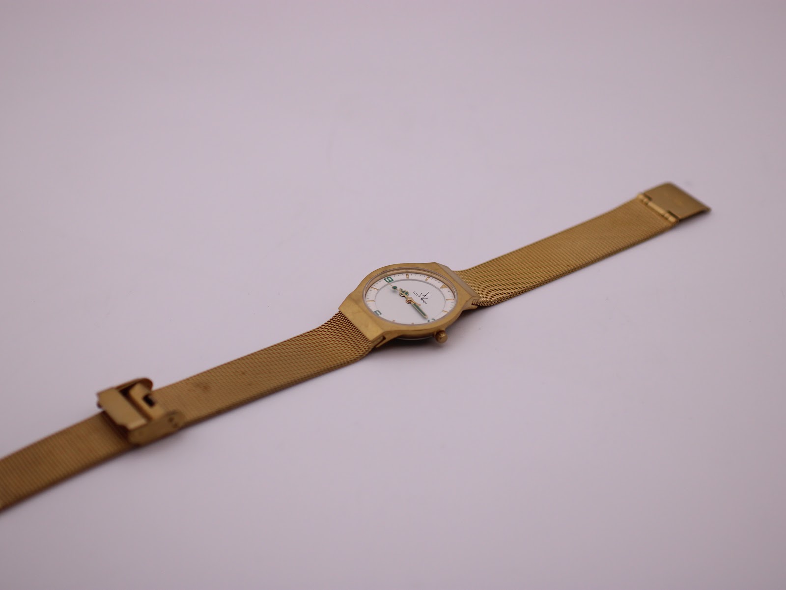 Top-down view of the full gold-tone Toy Watch laid flat, showing the mesh bracelet and clasp.
