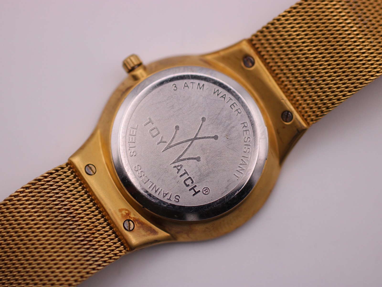 Detailed close-up of the stainless steel case back, engraved with 'TOY WATCH' logo and '3 ATM WATER RESISTANT'.