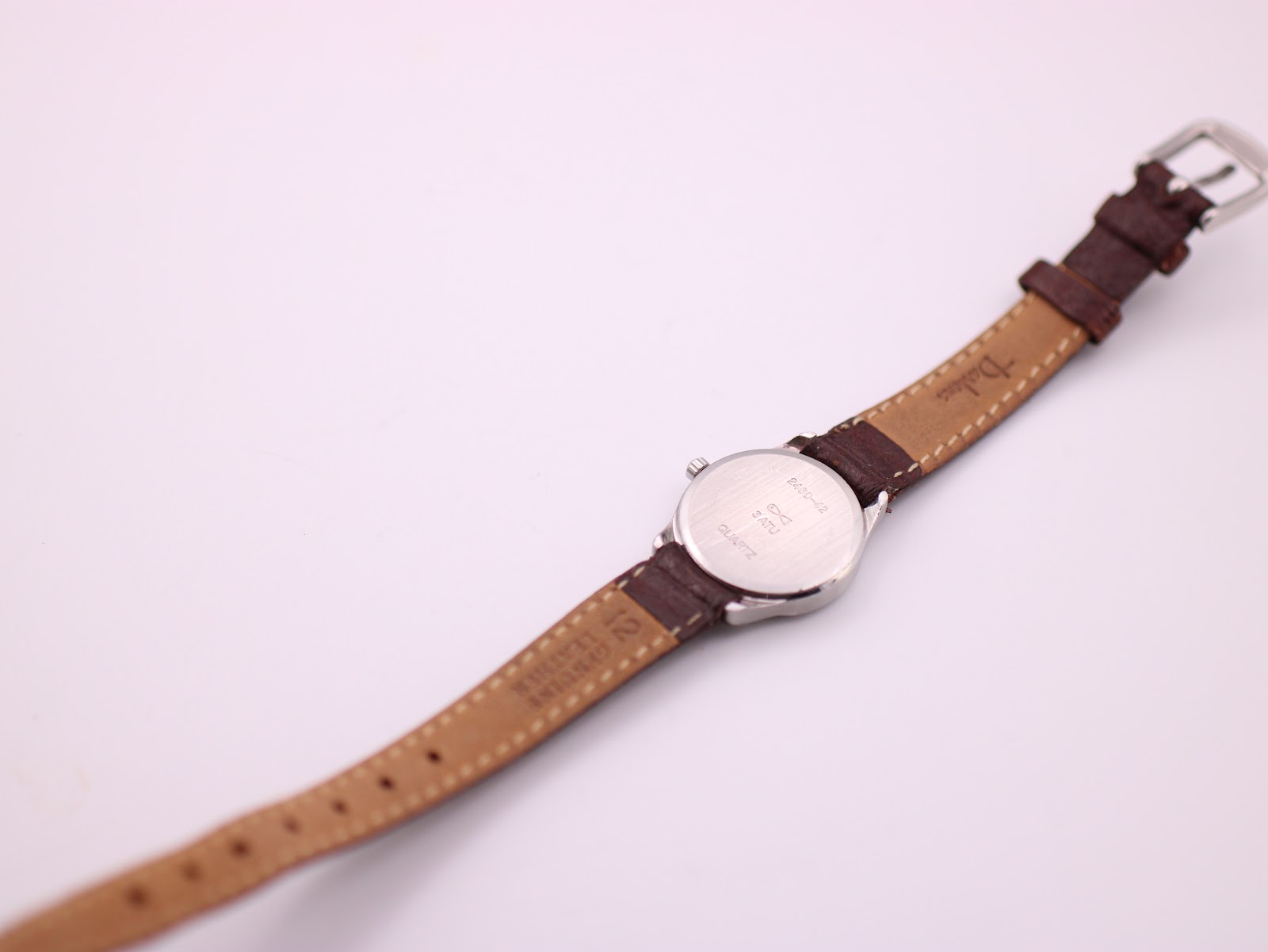 Back view of the Favre Leuba watch, showing the case back and the inner side of the leather strap.