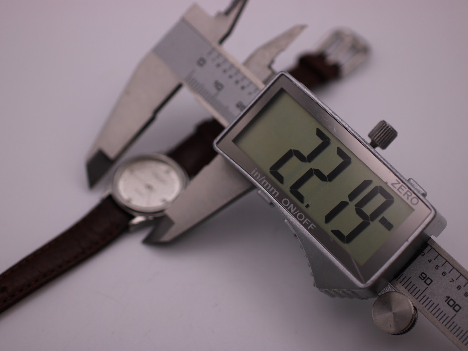 Another angle of the digital caliper measuring the Favre Leuba watch case, confirming the 22.19mm reading.