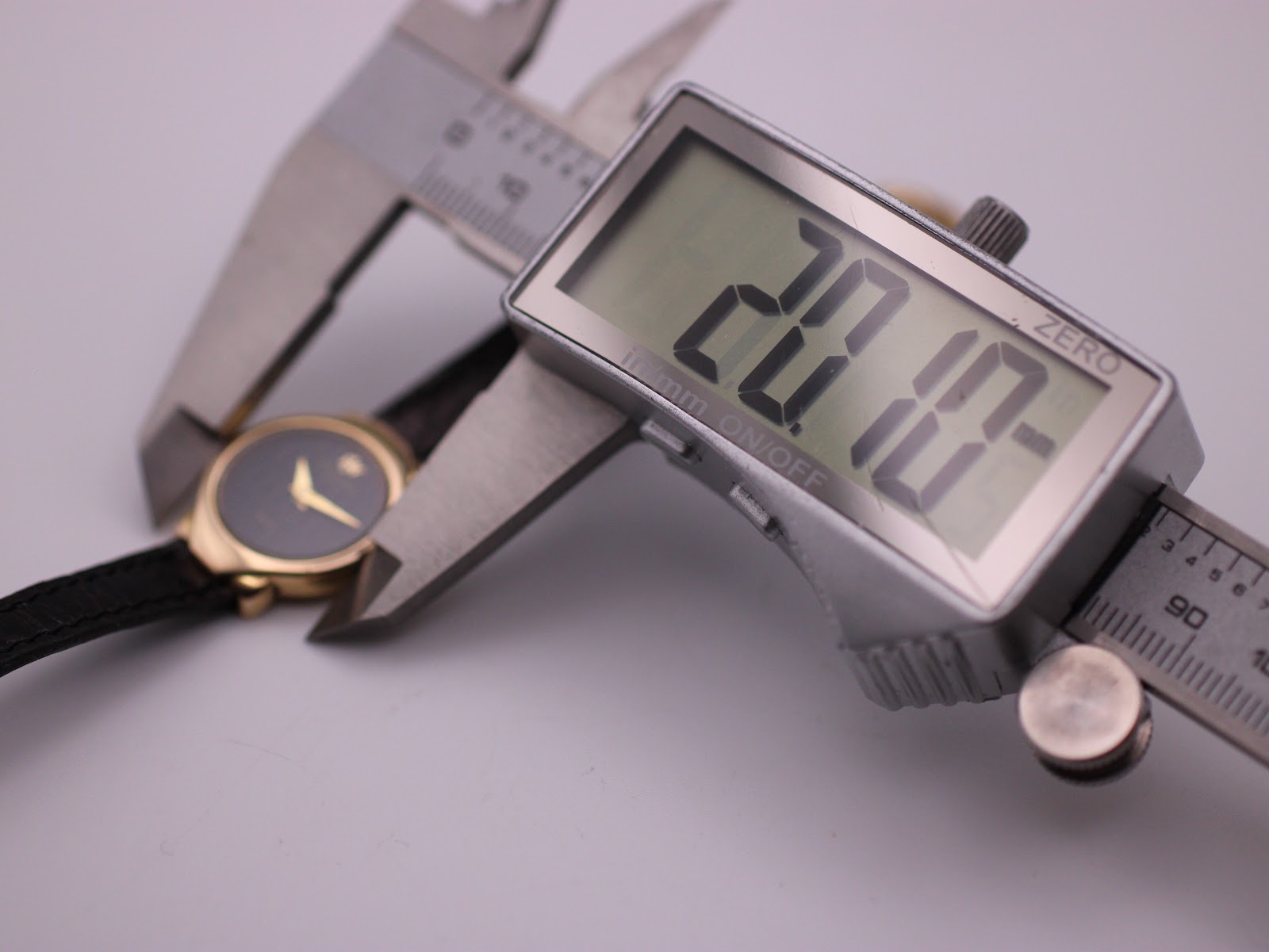 Photo showing a digital caliper measuring the case width of the Raymond Weil watch, displaying an exact measurement of 20.07mm.