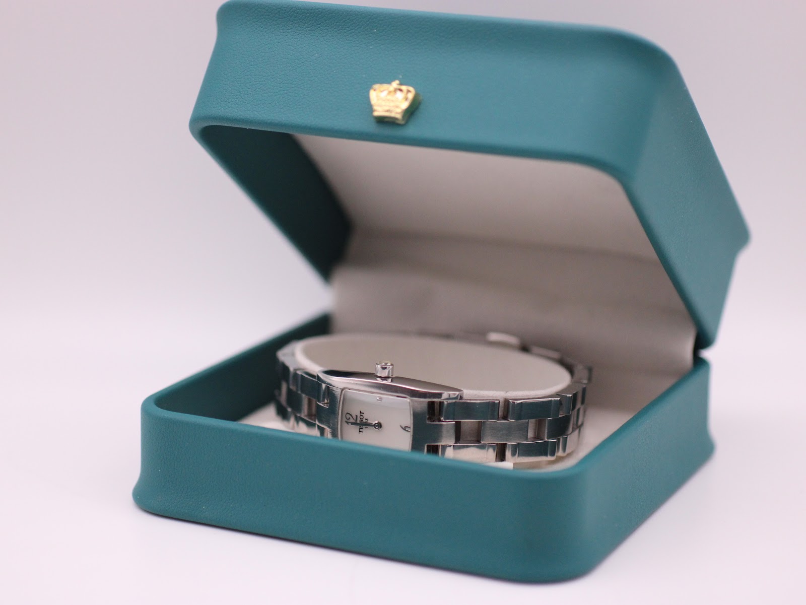 The Tissot T042109 A watch presented inside its original teal Tissot branded box.