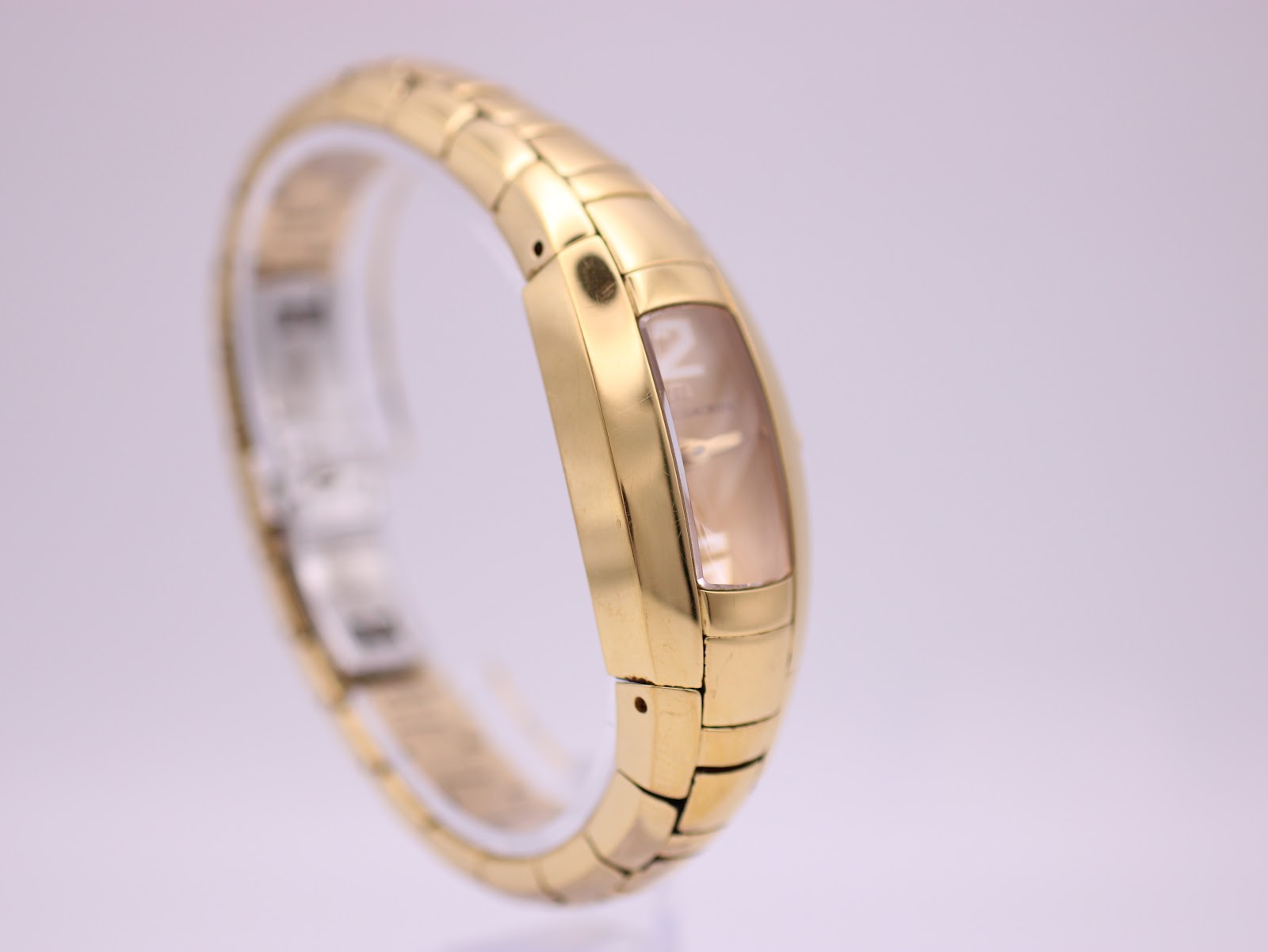 Side view of the Maurice Lacroix IN3012 watch on a stand, showing the crown and the seamless integration of the bracelet into the case.