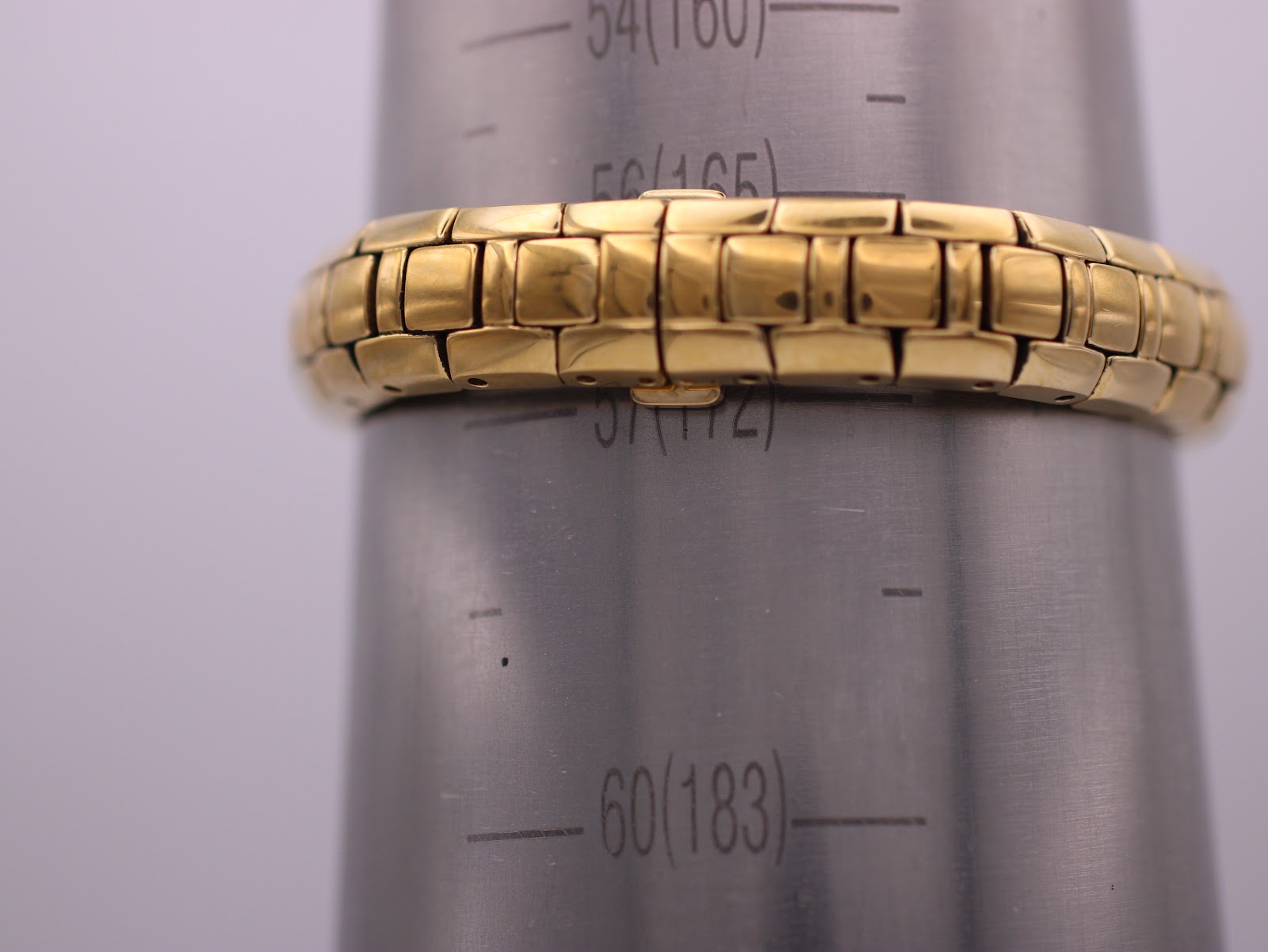 The Maurice Lacroix watch bracelet on a wrist sizing gauge, showing a measurement of approximately 16.2cm.