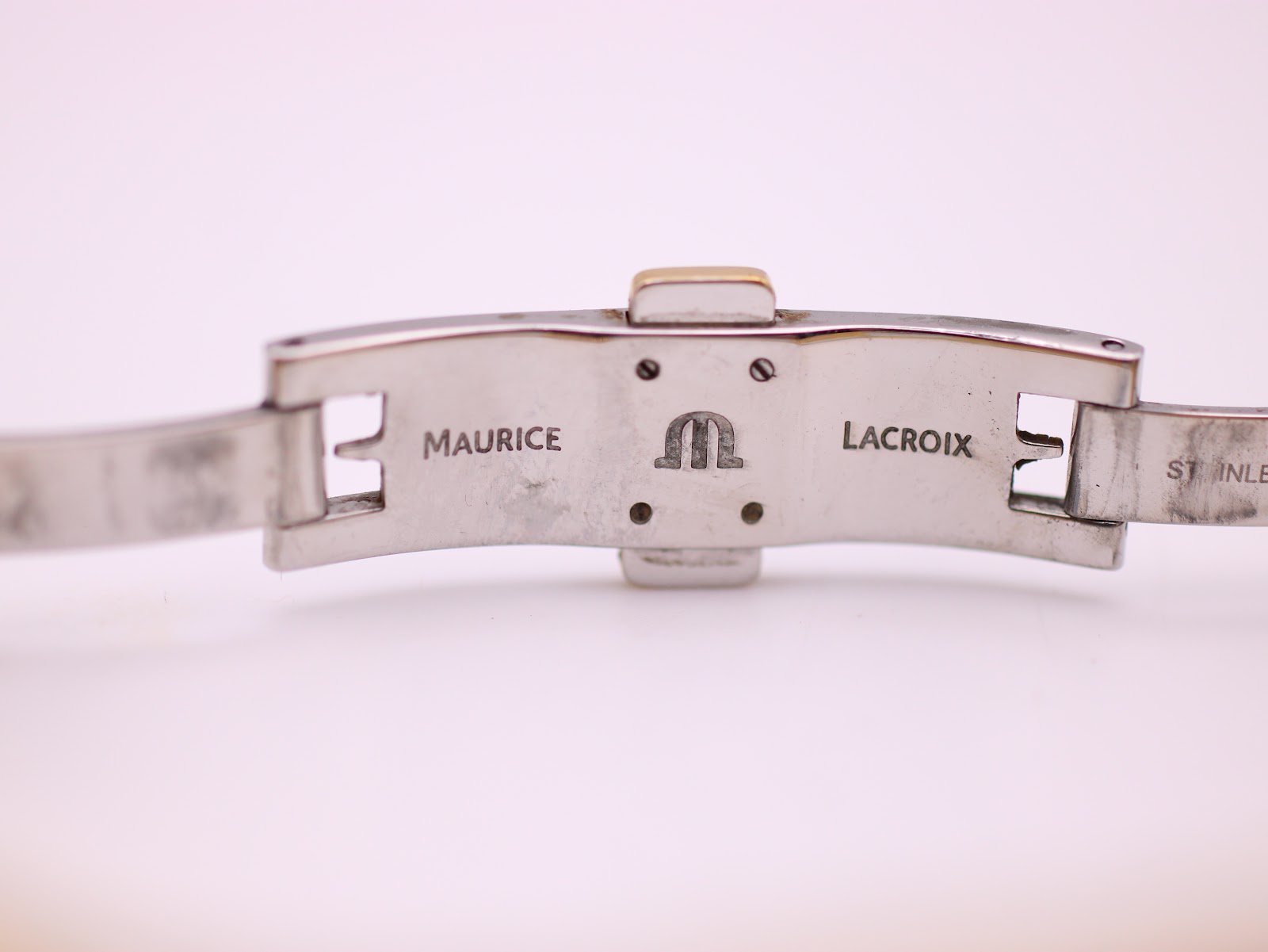 Interior view of the hidden butterfly clasp, clearly showing the "Maurice Lacroix" signature and logo engraved on the stainless steel.