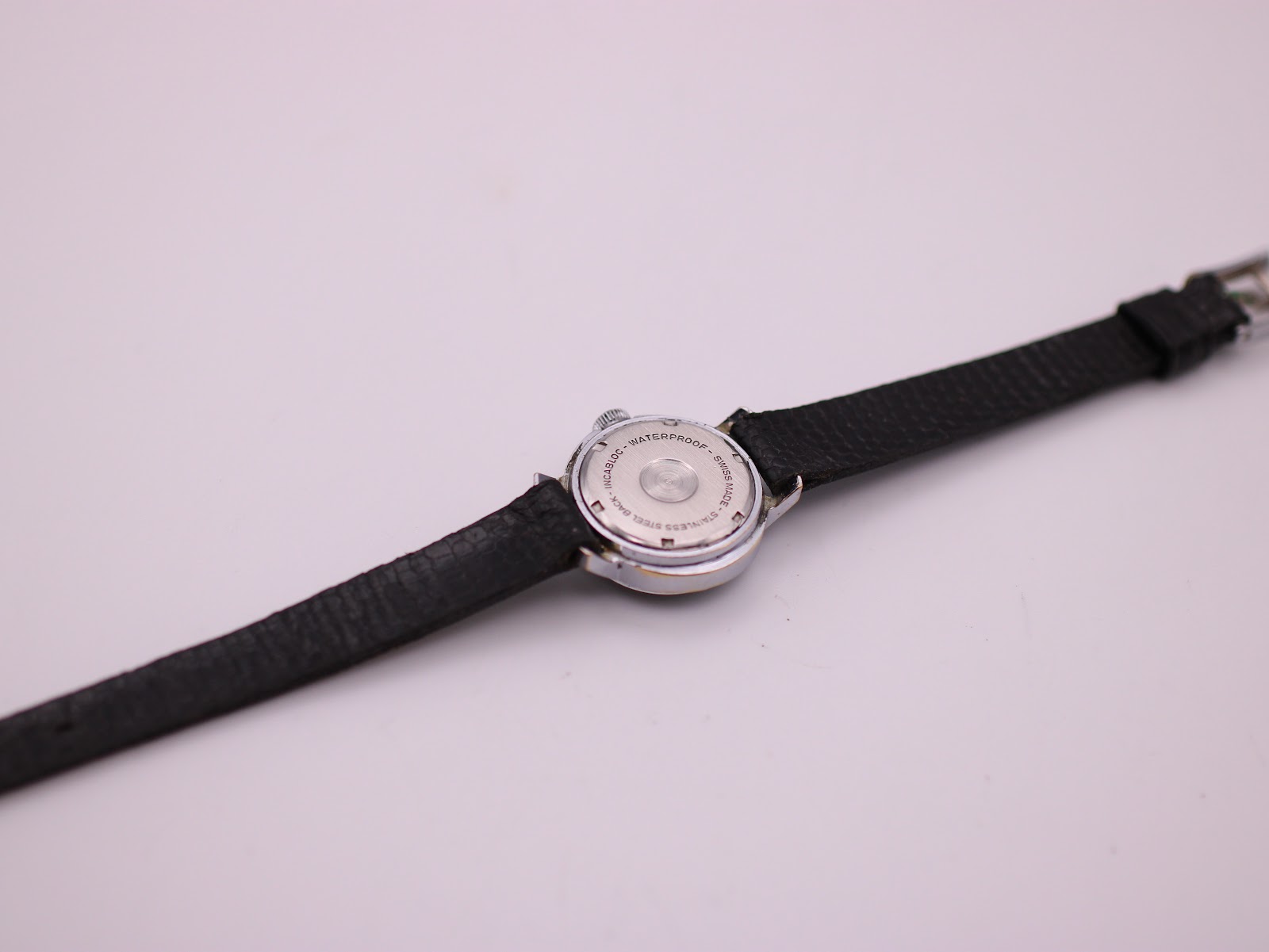 View of the Craftsman watch case back, clearly showing the 'Waterproof Stainless Steel Back Swiss Made' engraving.