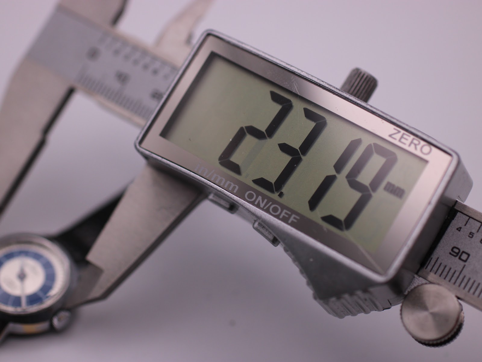 Digital caliper display showing the precise case diameter of the Craftsman watch as 23.19mm.