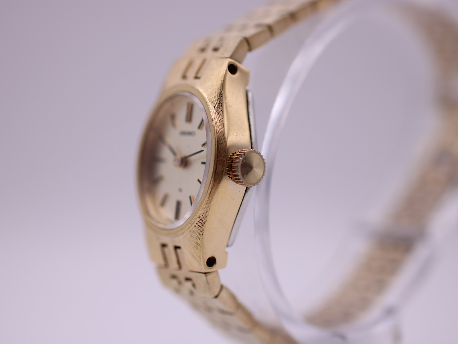 Right side profile view of the gold-tone Seiko watch, showing the octagonal case and fluted crown.