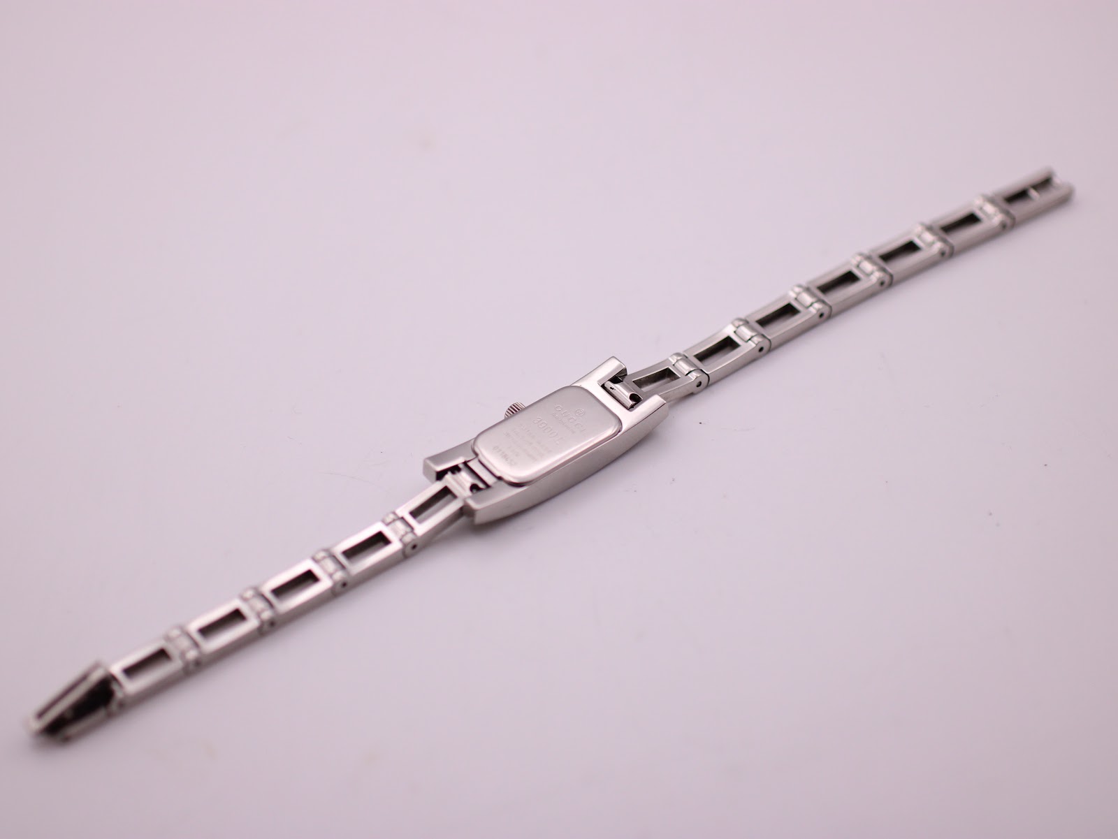 Rear view of the Gucci 3900L watch with the bracelet fully extended, showing the case back and links.
