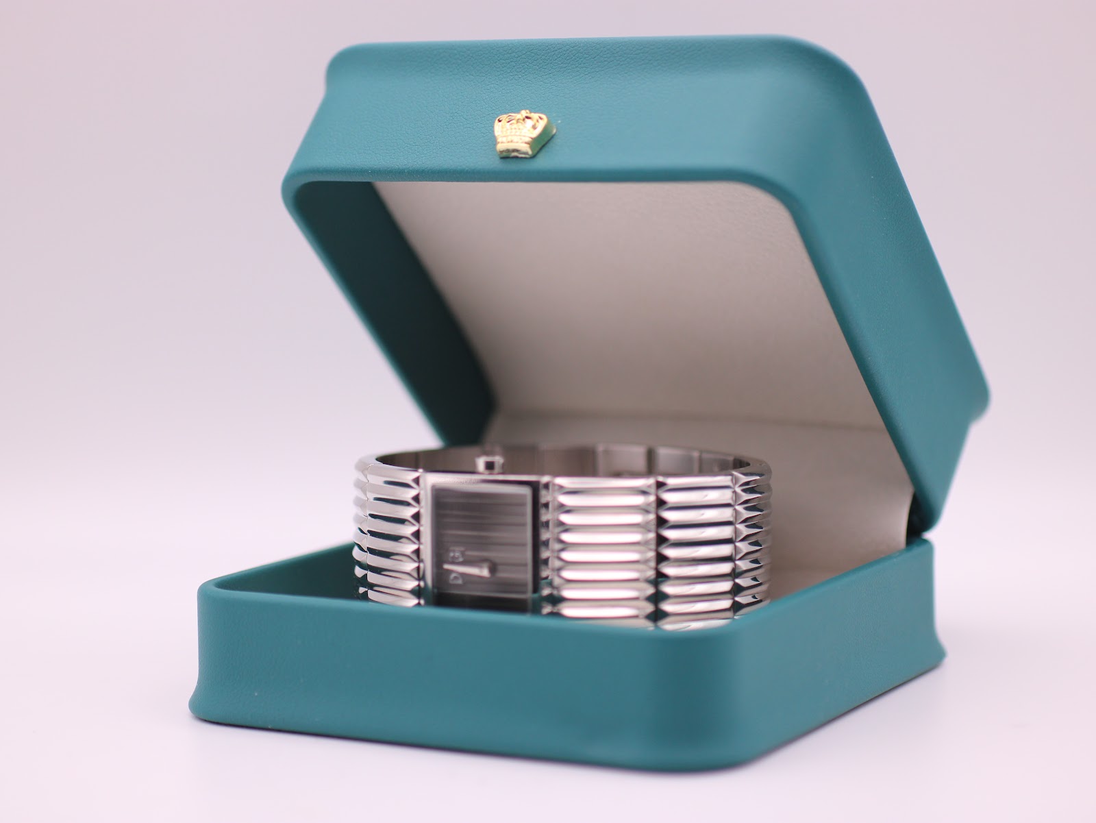 The D&G watch resting inside a generic green presentation box.