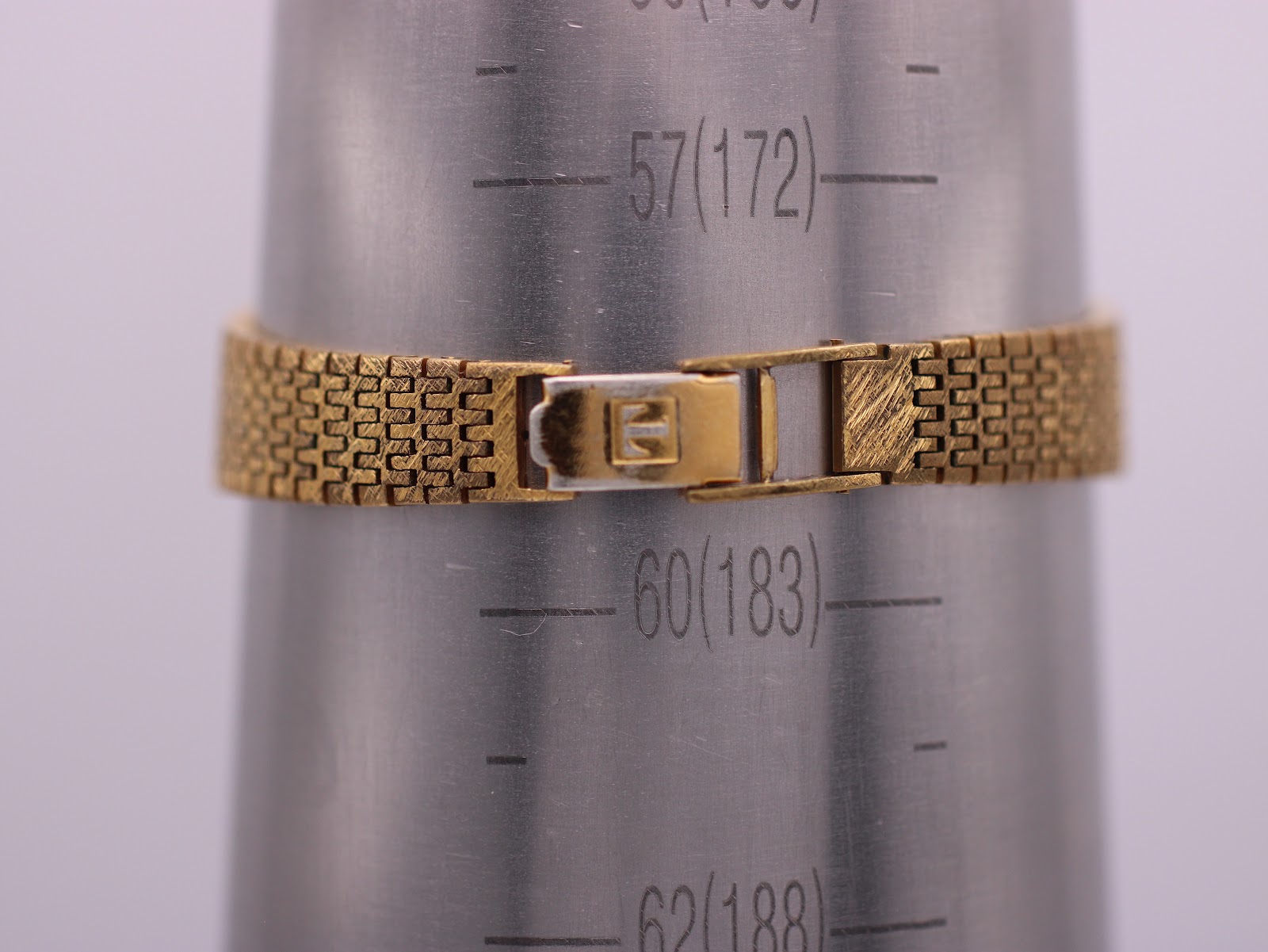 The Tissot Stylist bracelet clasped around a wrist sizing gauge, indicating a circumference of 172mm (17.2cm).