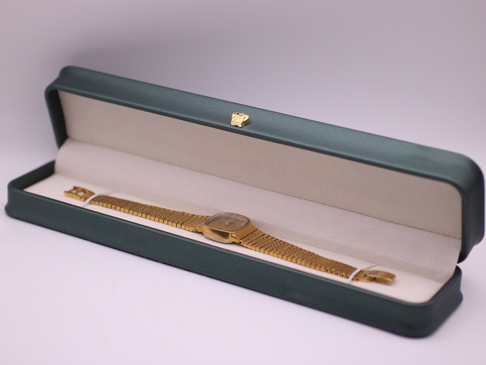 The Tissot Stylist watch presented in a green leatherette display box, a studio prop used for photography.