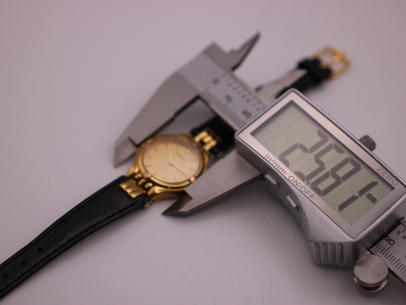 Digital caliper measuring the watch case diameter at 26.8mm, confirming the size.