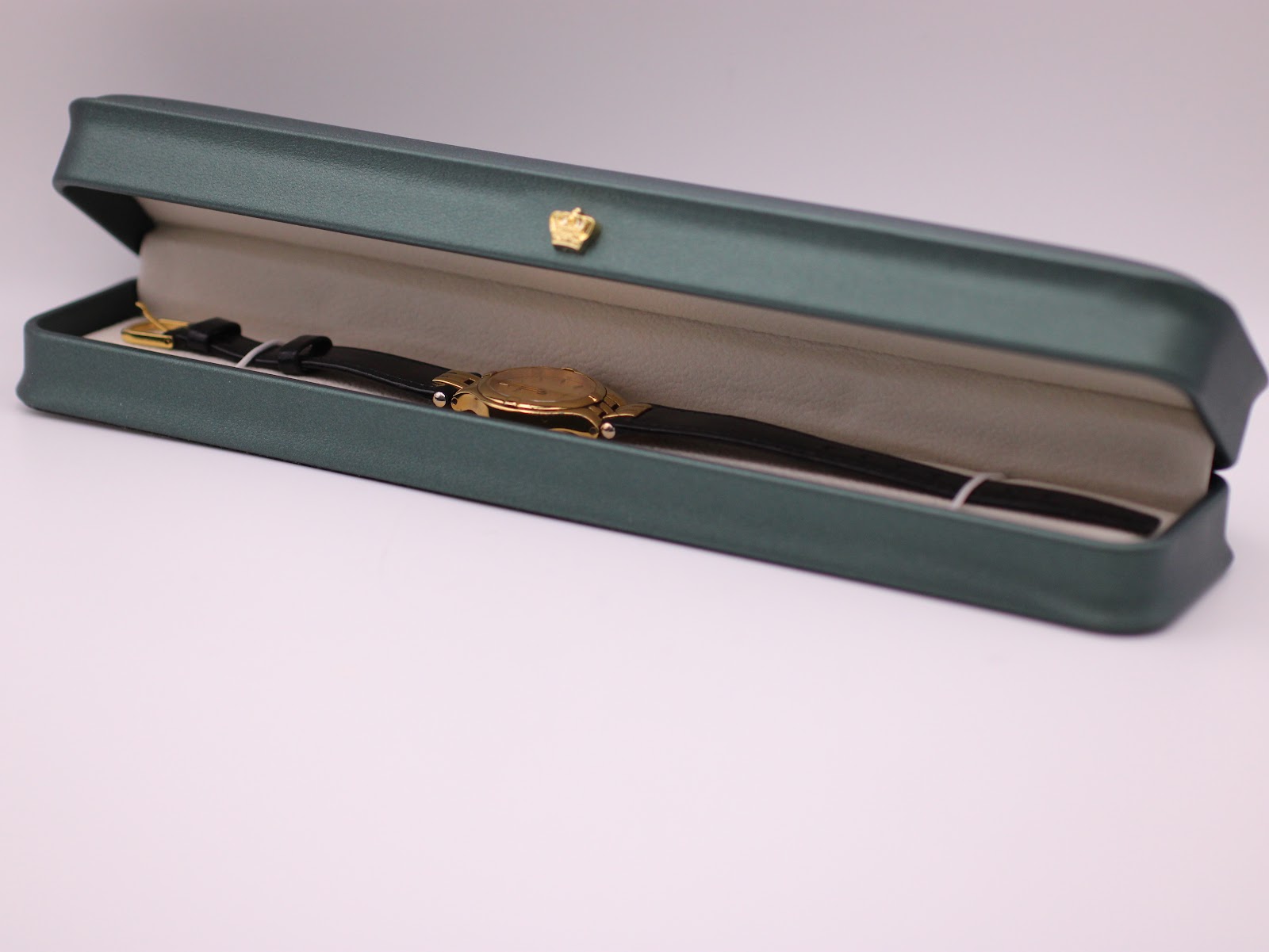 The Tissot Stylist watch displayed in a green presentation box, a studio prop.