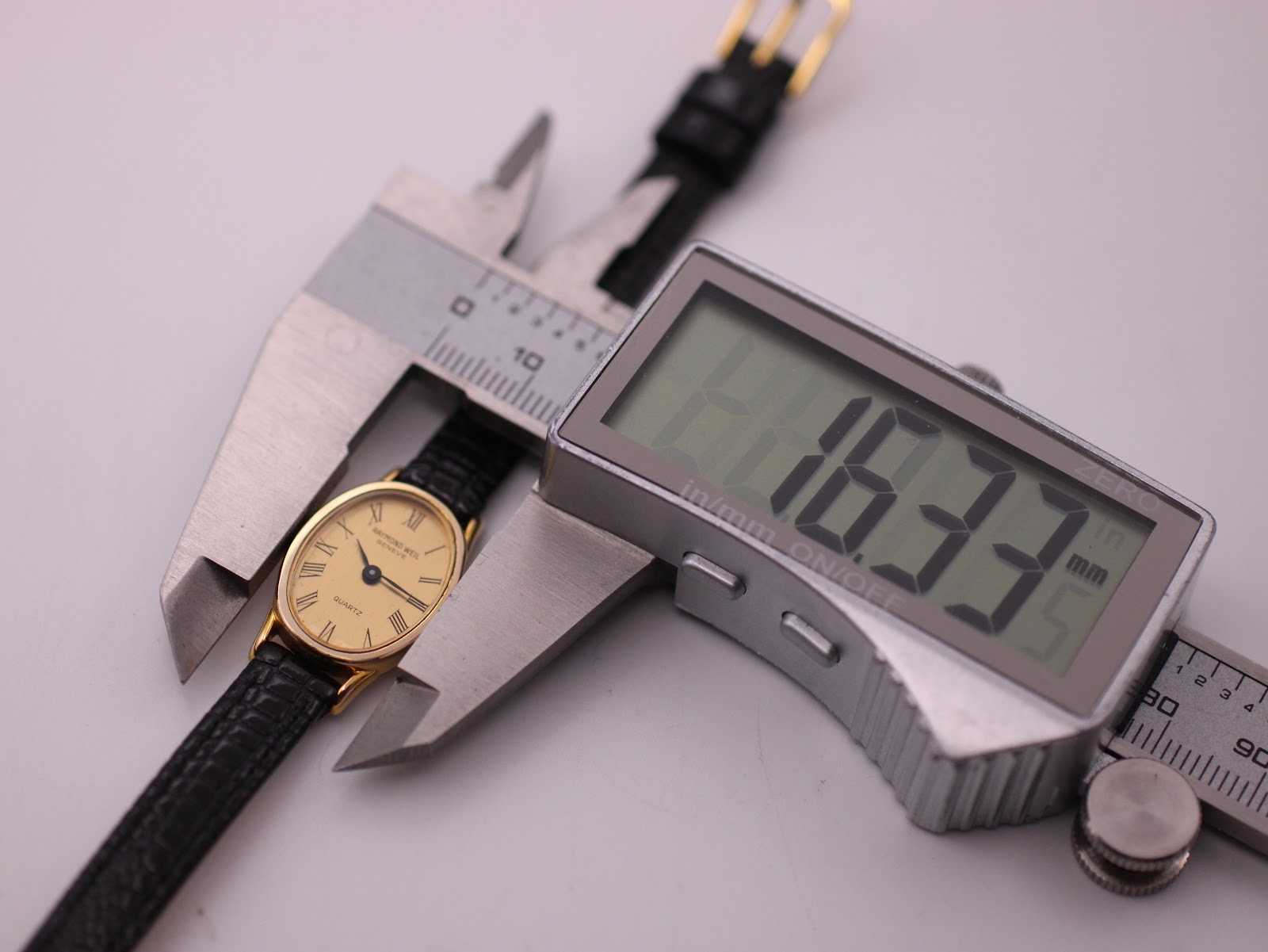 View of the Raymond Weil watch placed in digital calipers, displaying a precise case width measurement of 16.33mm.