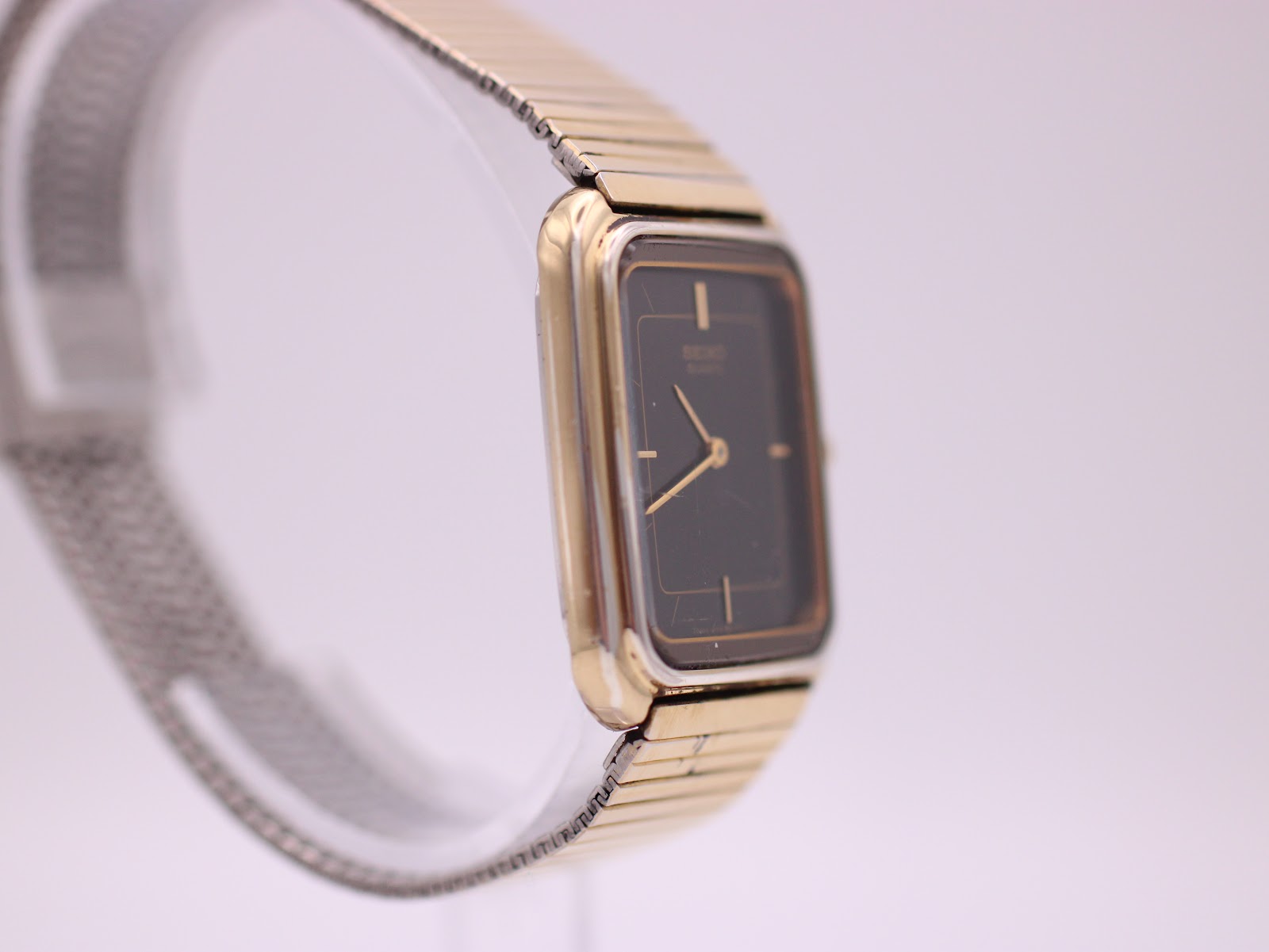 Opposite side profile of the Seiko watch, highlighting the slim case and integrated mesh bracelet.