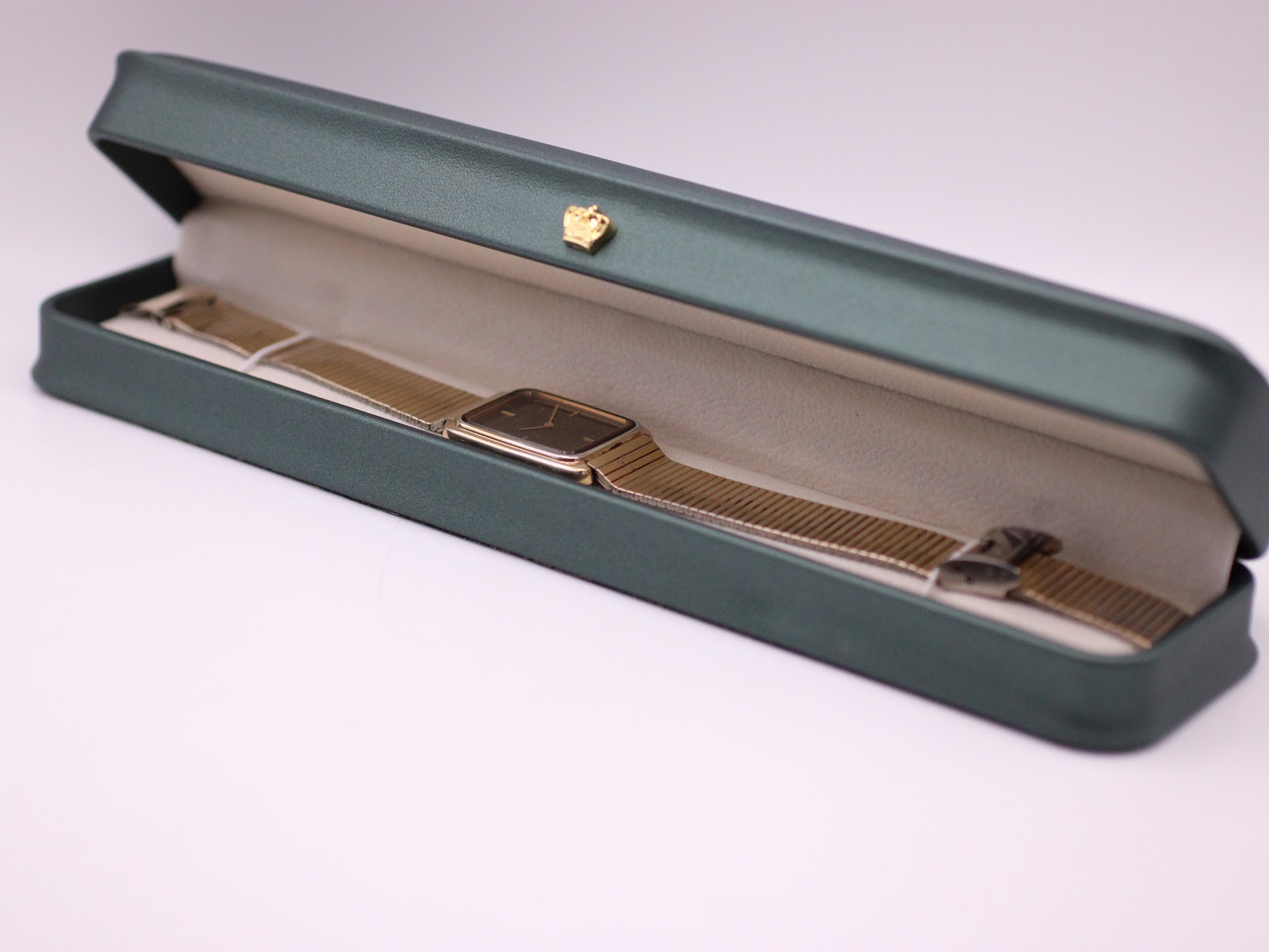 The Seiko watch neatly presented in a generic green leatherette display box, a studio prop.