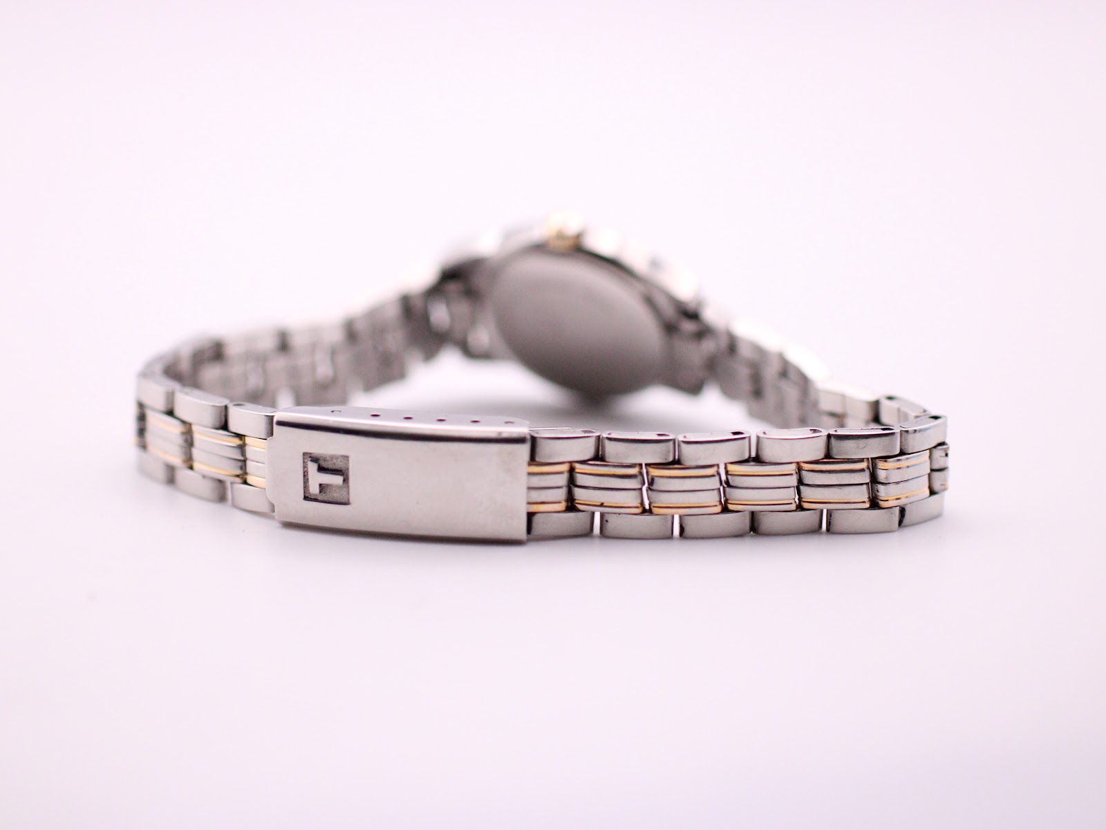View of the two-tone bracelet with the signed Tissot 'T' fold-over clasp.