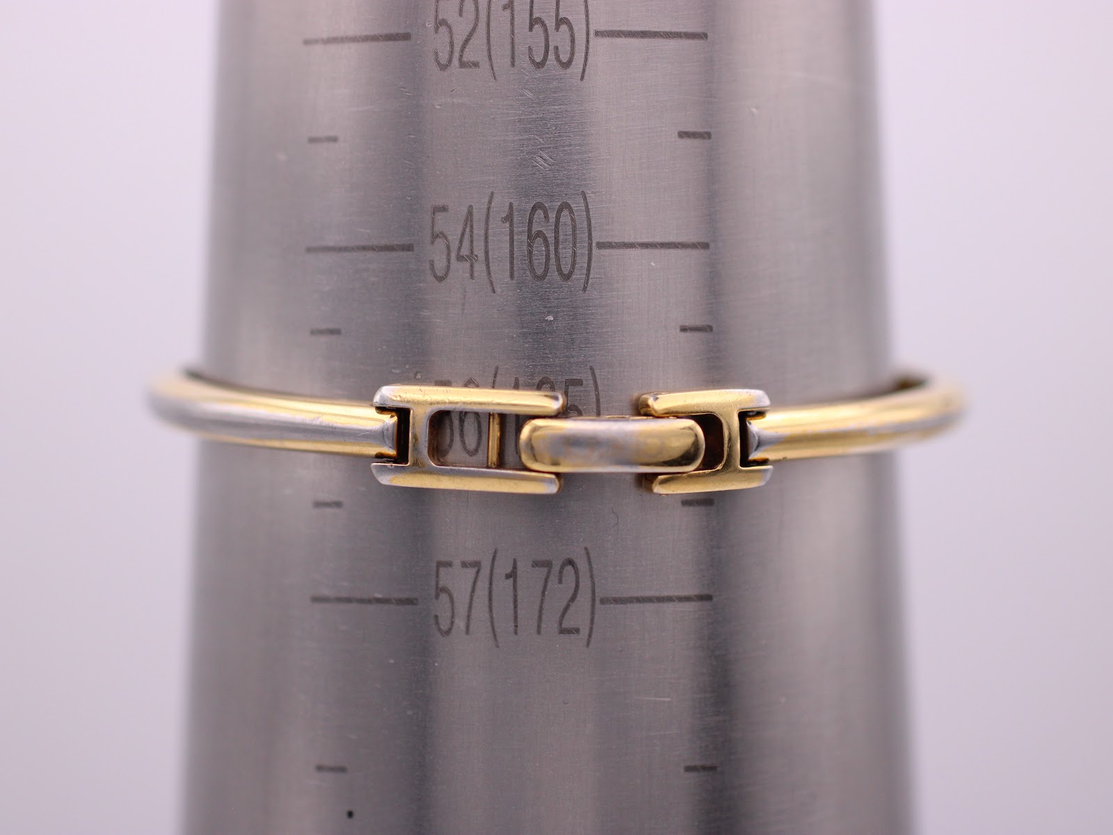 Rear view of the integrated gold-tone bracelet's butterfly clasp on a wrist sizing gauge, indicating a wrist circumference of approximately 160mm / 16cm.