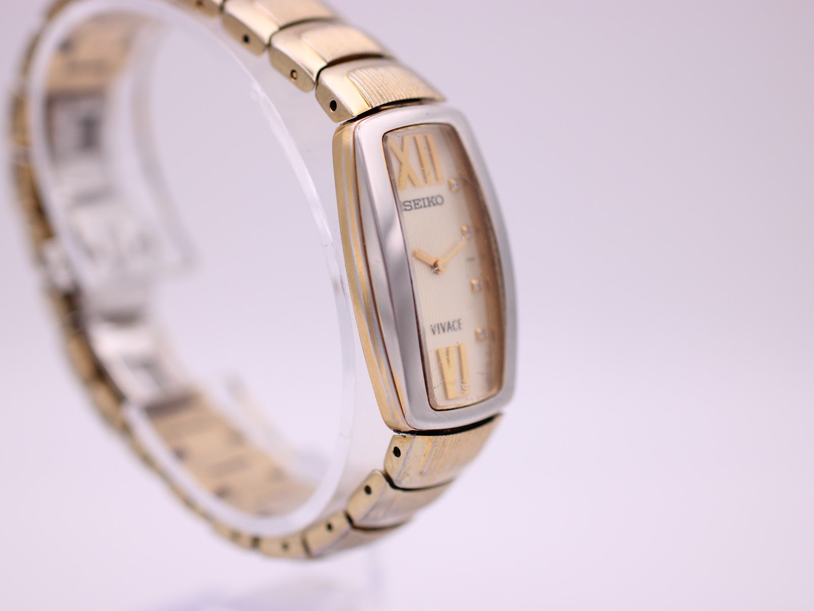 Side view of the Seiko Vivace watch showing the gold-tone crown and the two-tone case and bracelet details.