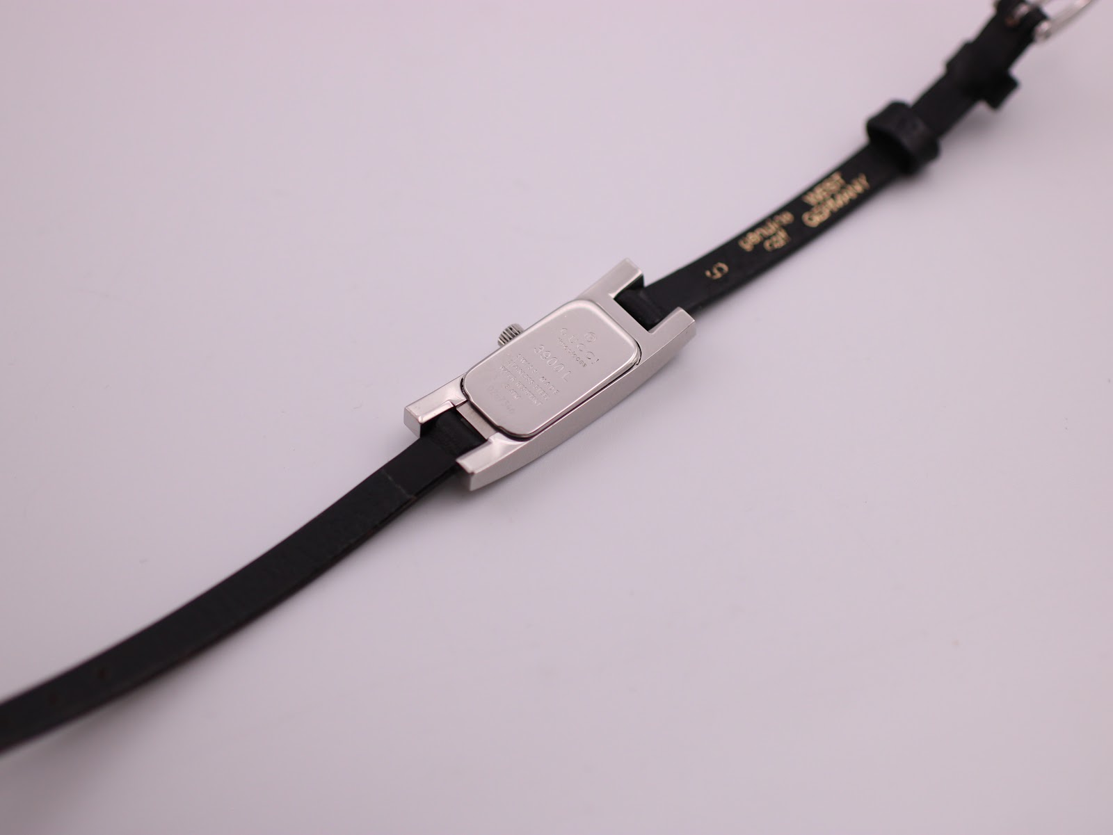 Rear view of the Gucci 3900L watch laid flat, showing the case back and interior strap markings.