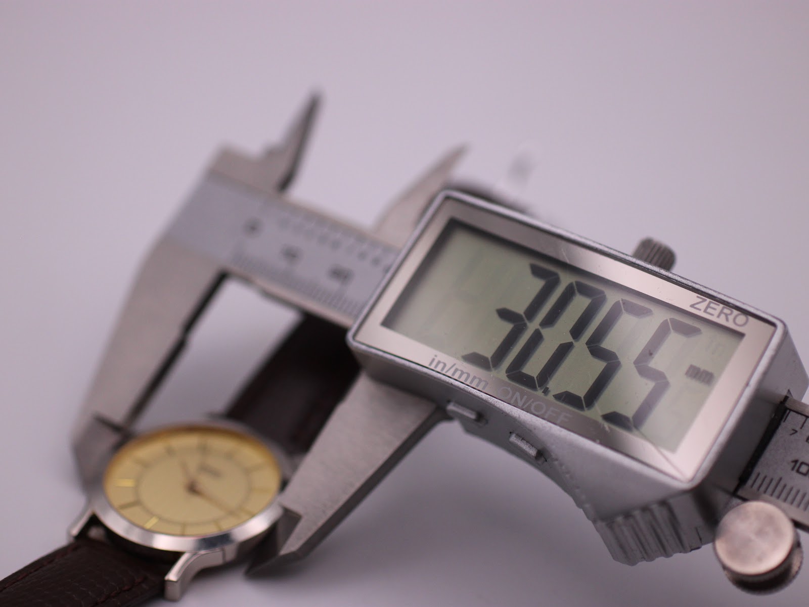 Digital caliper measuring the watch case diameter at precisely 30.55mm.