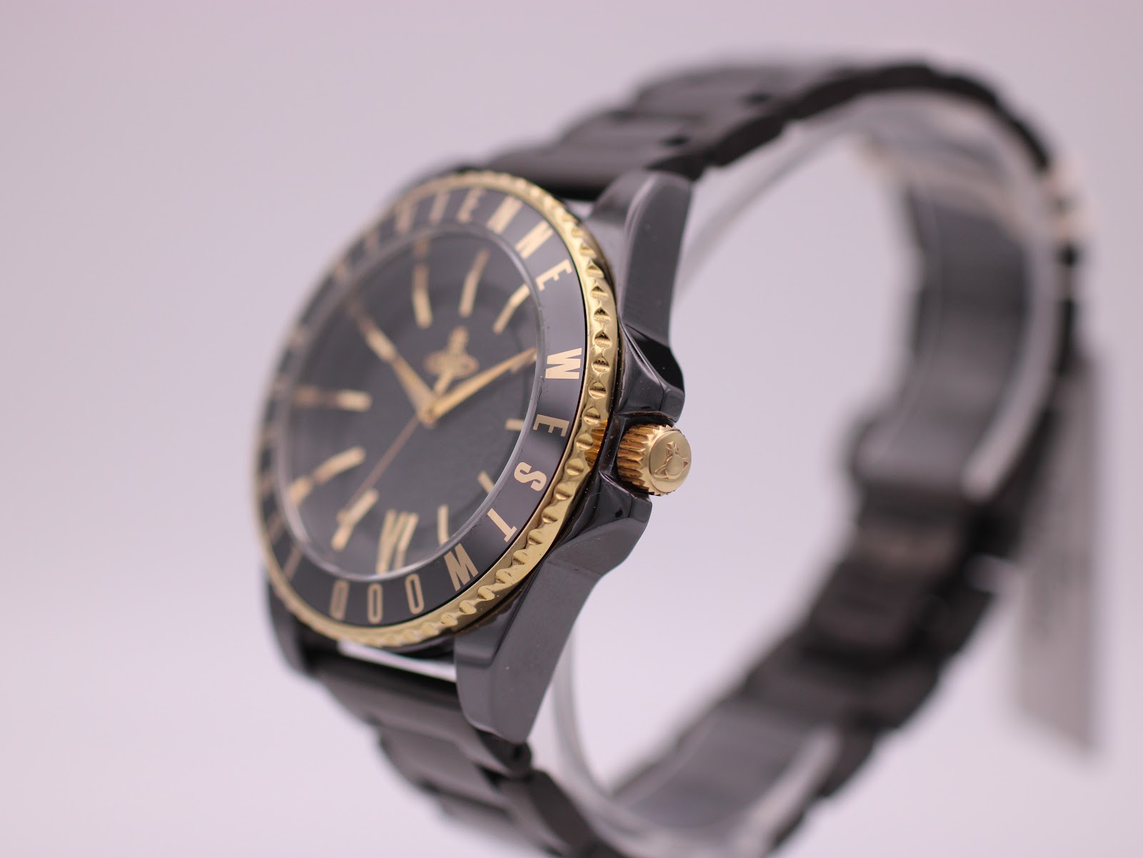 Right-side profile view of the Vivienne Westwood watch showing the gold-tone crown and fluted bezel edge.