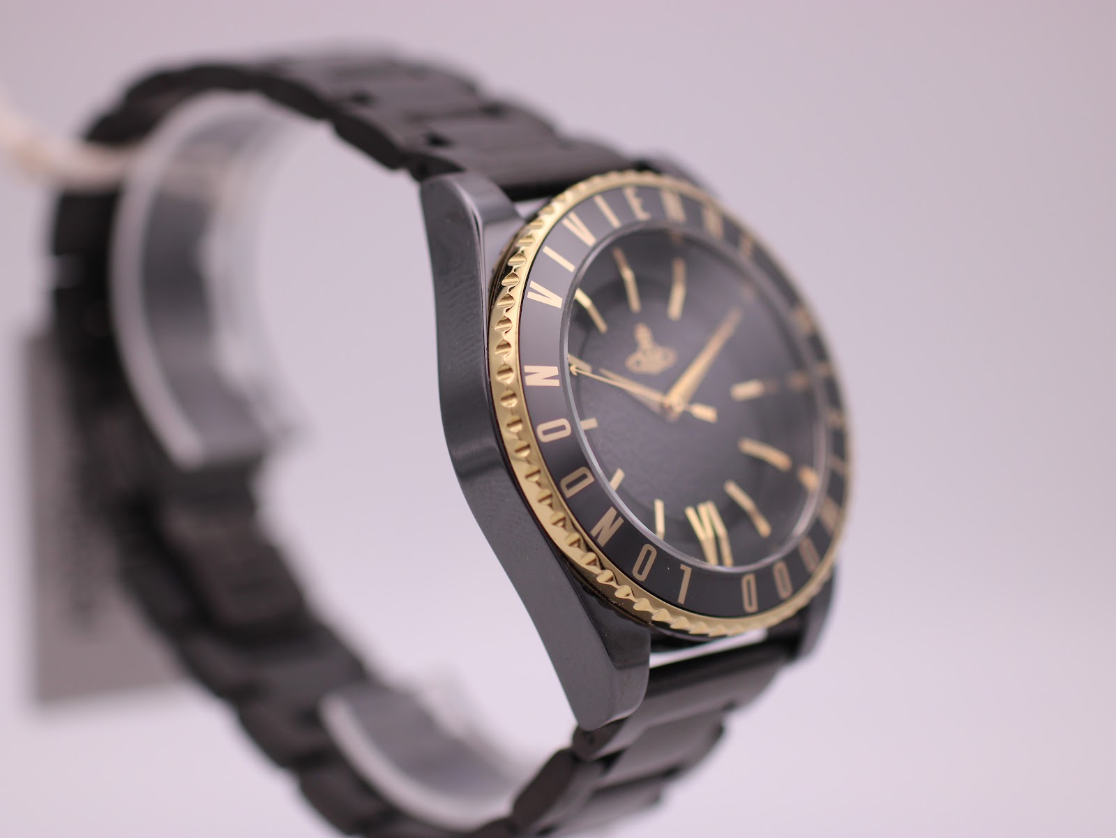 Left-side profile view of the Vivienne Westwood watch highlighting the black ceramic case and gold-tone bezel.