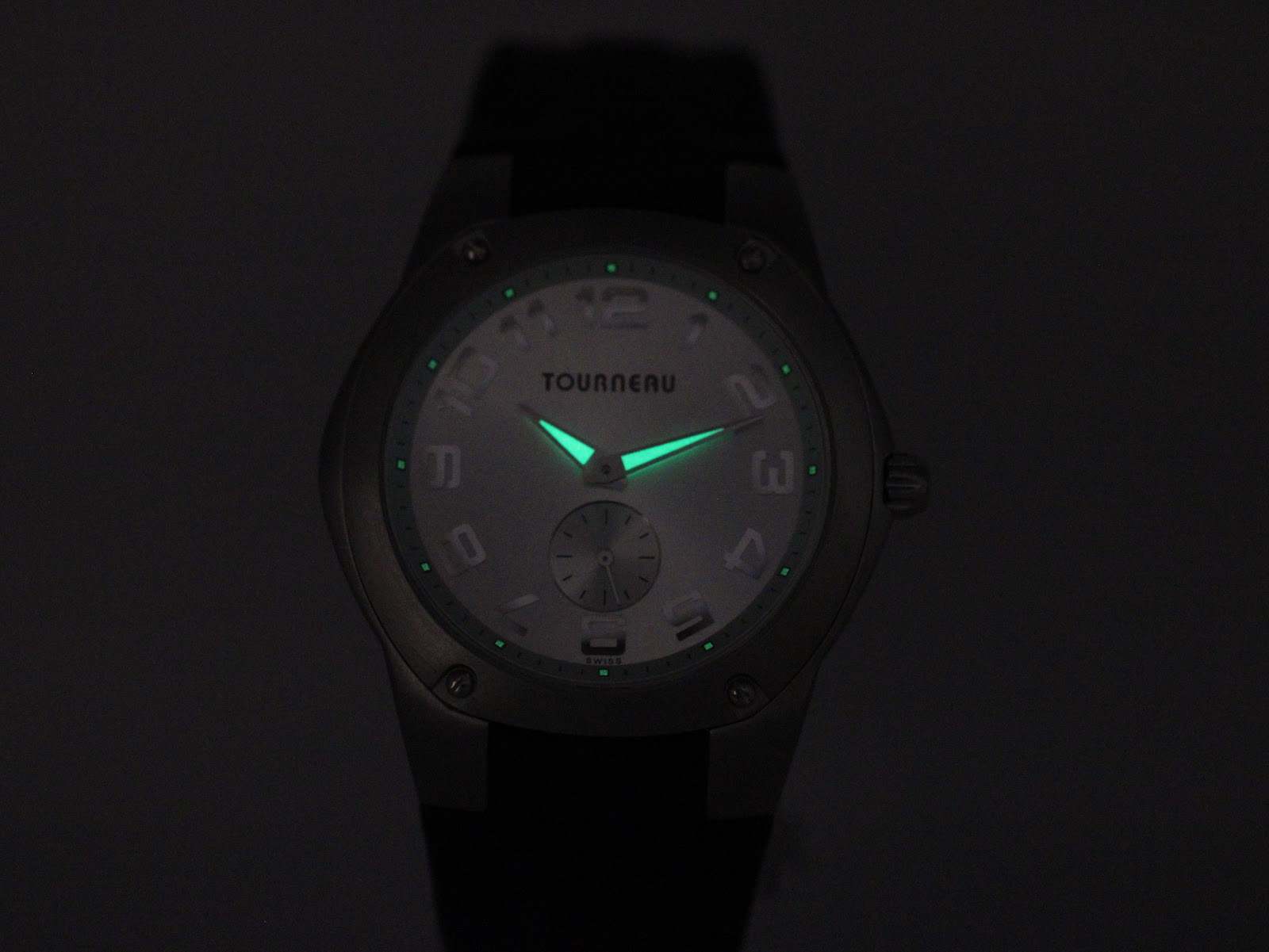 Lume shot of the watch dial in darkness, demonstrating the glowing hour markers and hands.