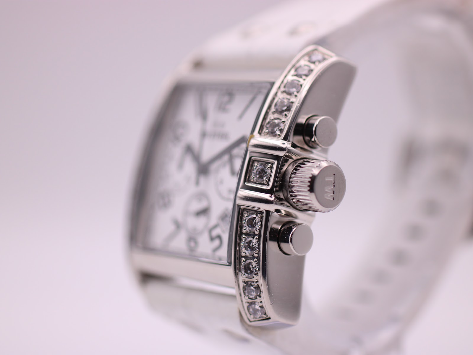 Side view of the watch, showing the crown with 'TW' logo and the diamond-set bezel.