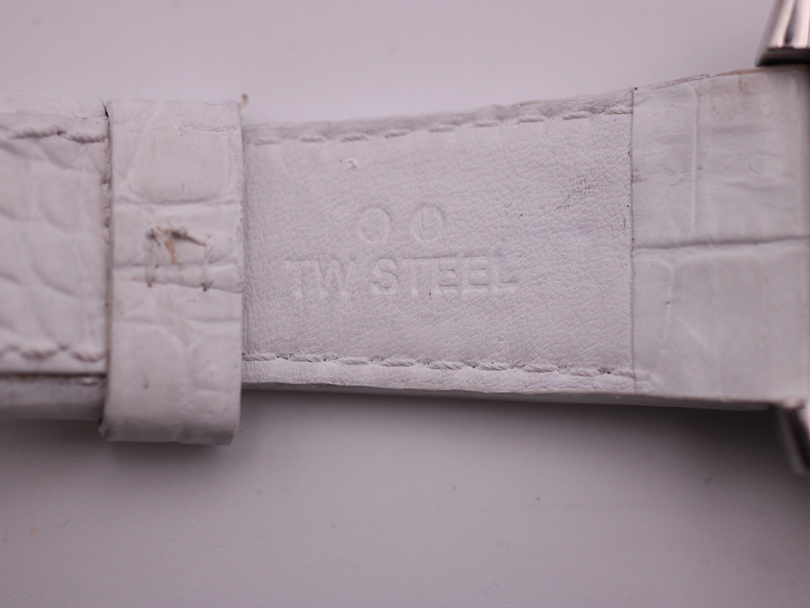 Interior view of the white leather strap, showing 'TW STEEL' embossing and alligator pattern.