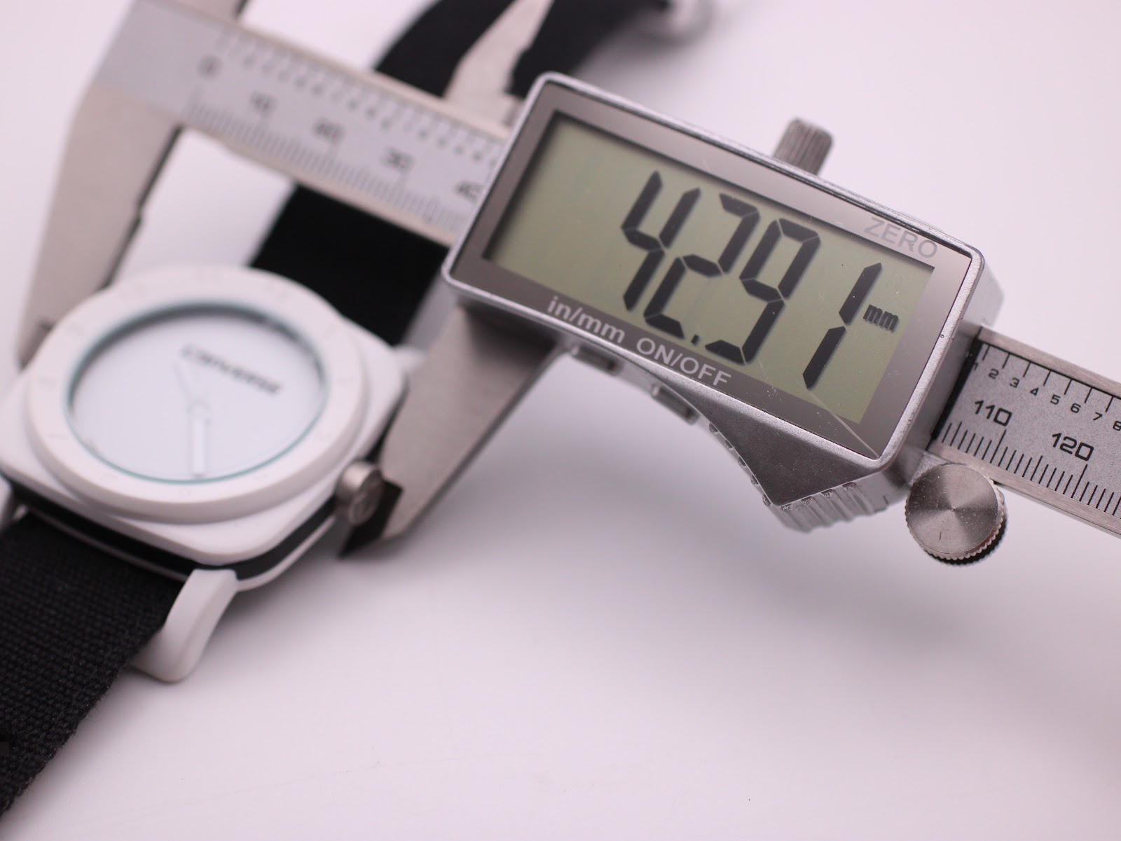 Digital caliper measuring the case diameter of the Converse VRQ22 at 42.91mm.