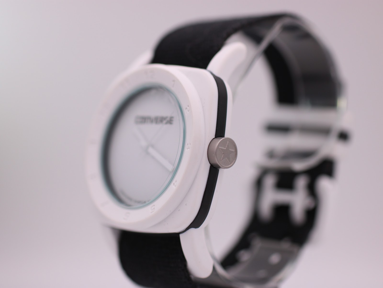 Angled side view of the Converse VRQ22, showing the white case, black trim, and crown with star logo.