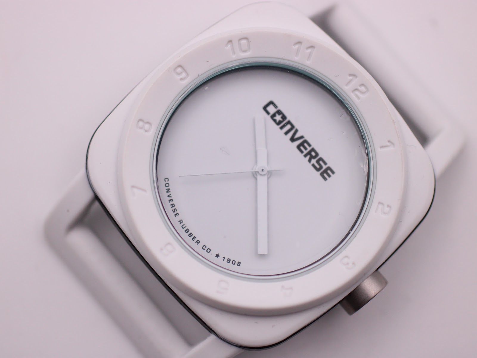 Close-up top-down view of the Converse VRQ22 dial, showing the branding and raised hour markers.