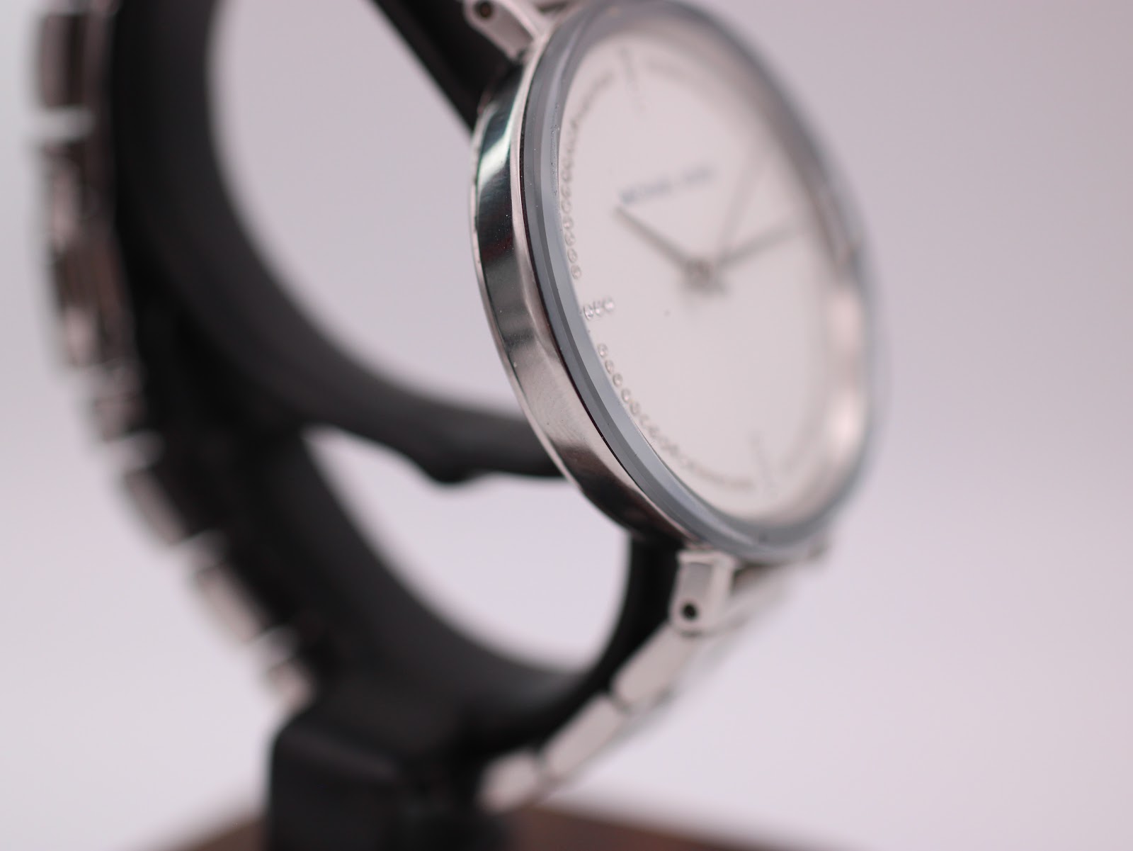 Alternative angled side view of the Michael Kors watch, highlighting the smooth curve of the case.
