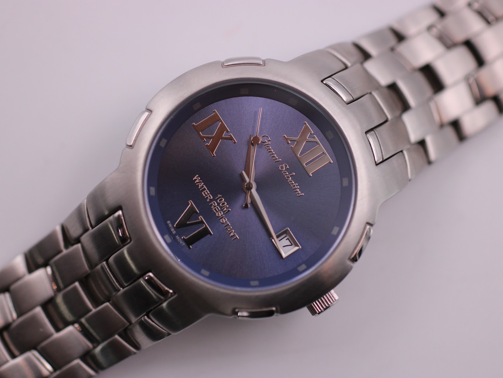 Close-up angled view of the watch dial, showing Roman numerals and date window.