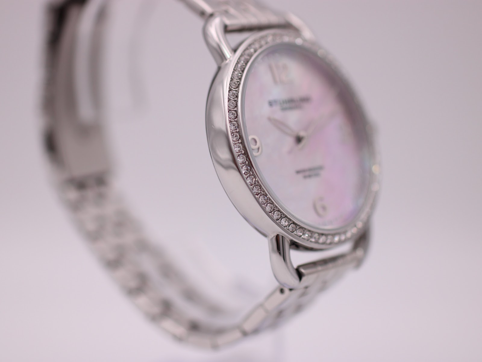 Opposite angled close-up of the Stührling Original watch highlighting the crystal-set bezel and polished case.